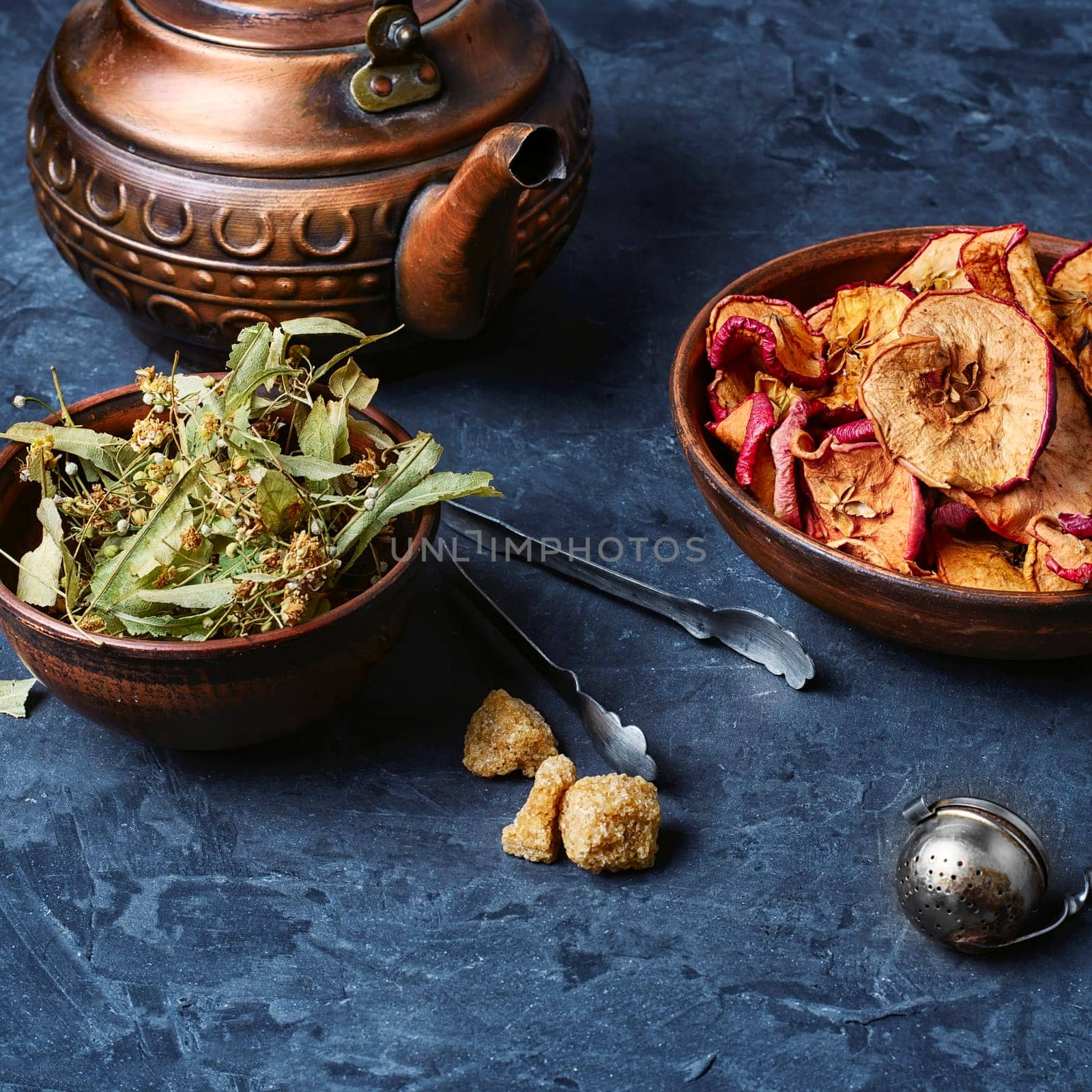 Clay bowl with a sprig of lime on slate background