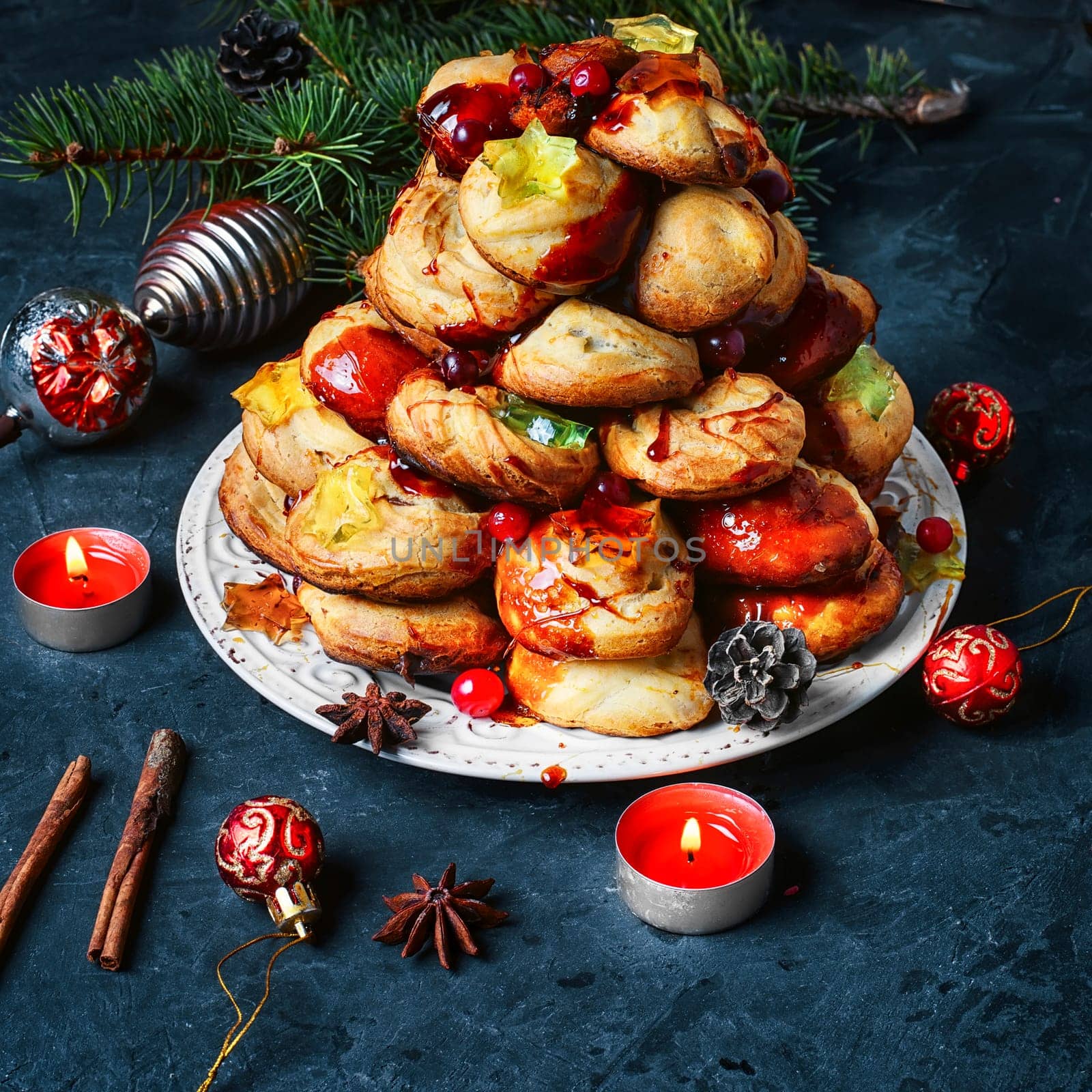 croquembouche cake decorated with caramel threads and cranberries with the marmalade