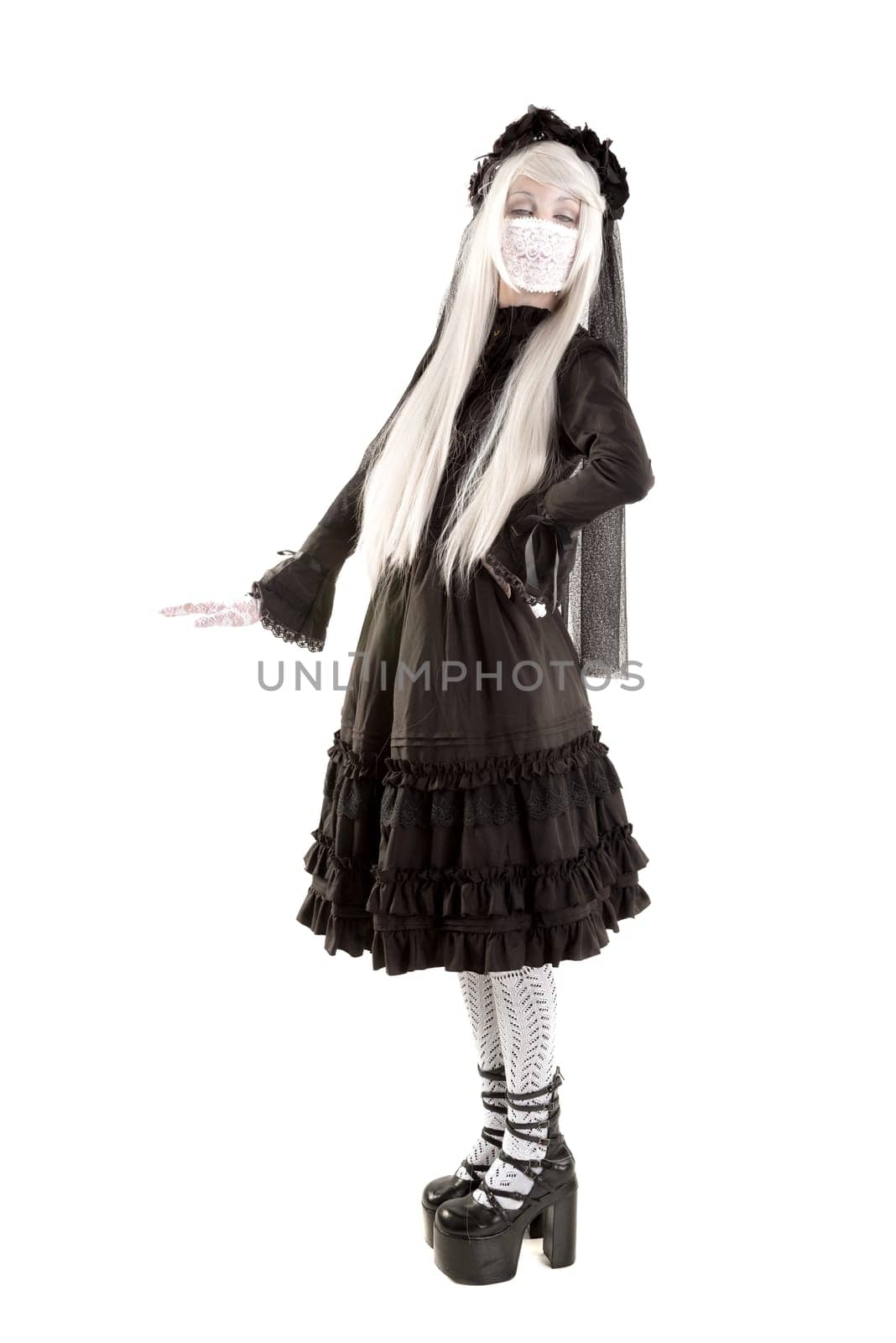 Widow in a black dress with white eyes looking like a doll isolated in white