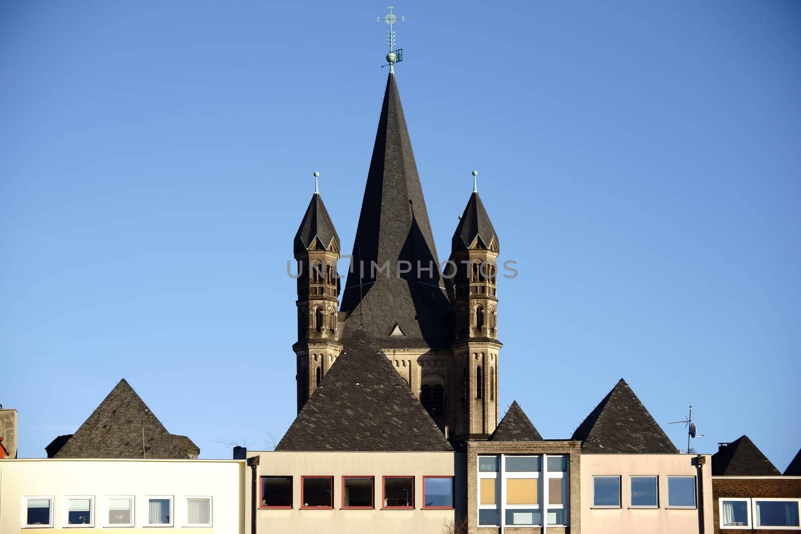 The colorful roofs of the old town in Cologne with the towers of the Groß Sankt Martin Church.