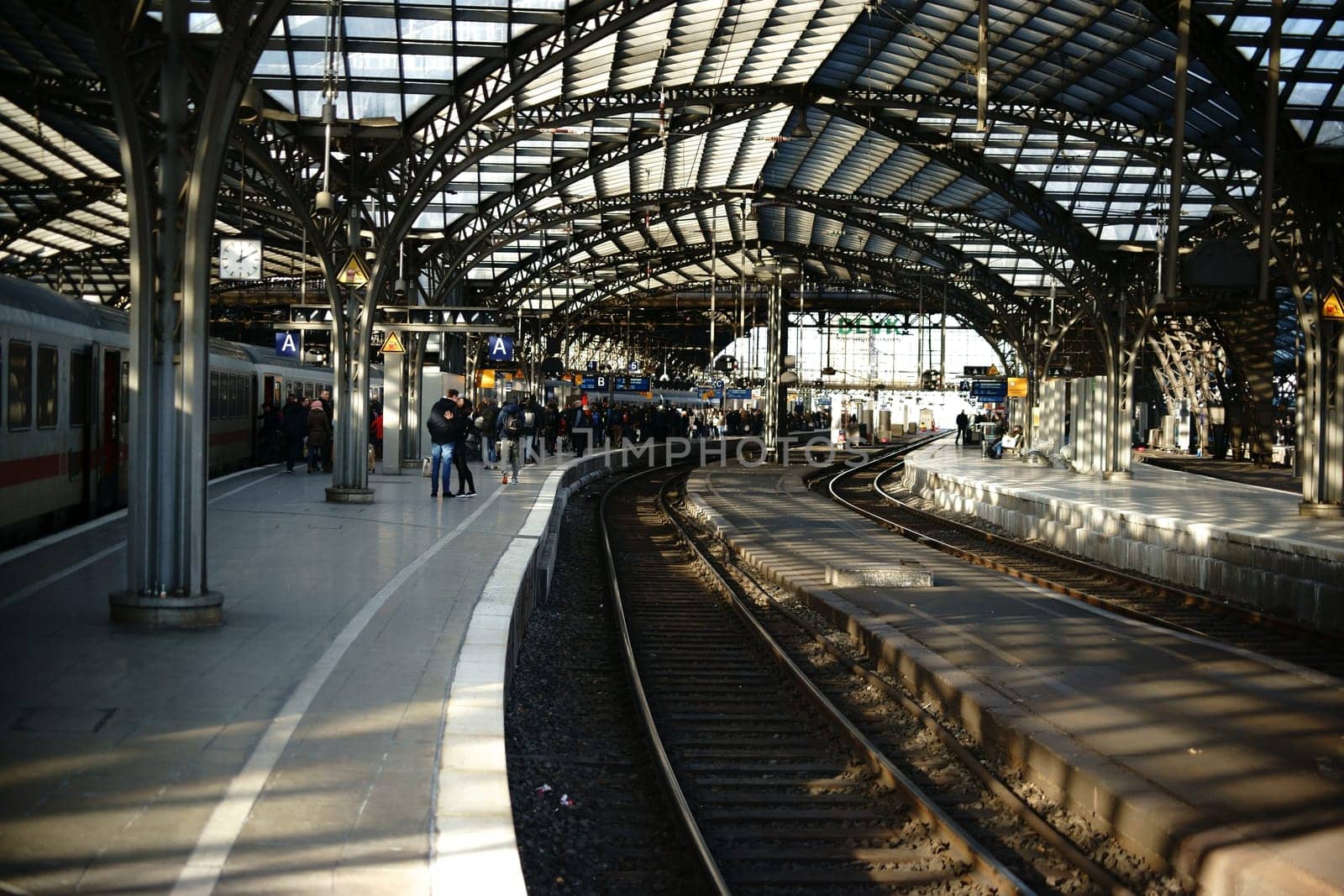 Cologne,Germany - November 24,2016: Passengers stand at a railway track of Cologne Central Station under a glass canopy on November 24,2016 in Cologne.