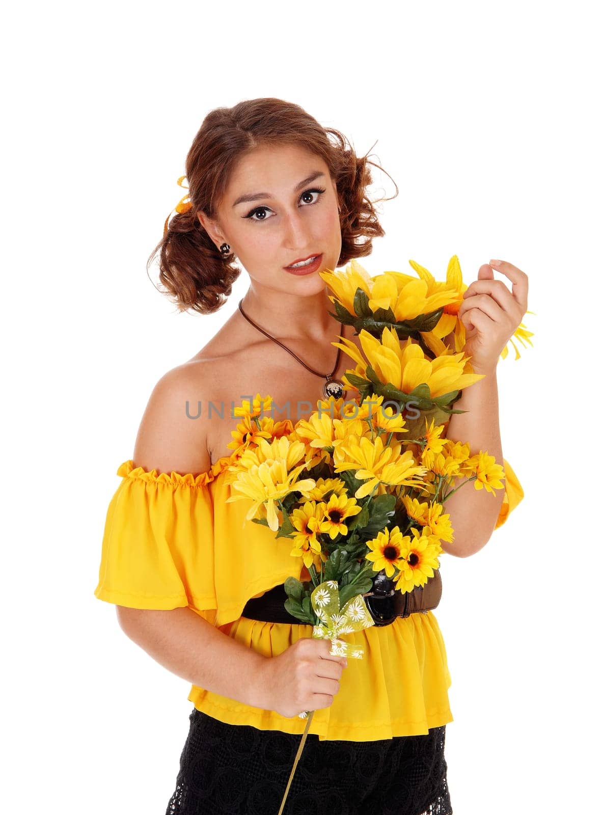 Gorgeous young woman in a yellow blouse holding a bunch of .sunflowers, smiling, standing isolated for white background..