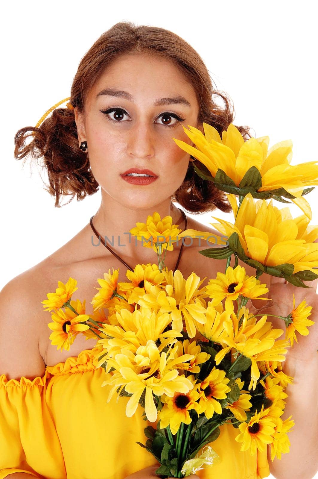Gorgeous young woman in a yellow blouse holding a bunch of .sunflowers, standing closeup  isolated for white background..