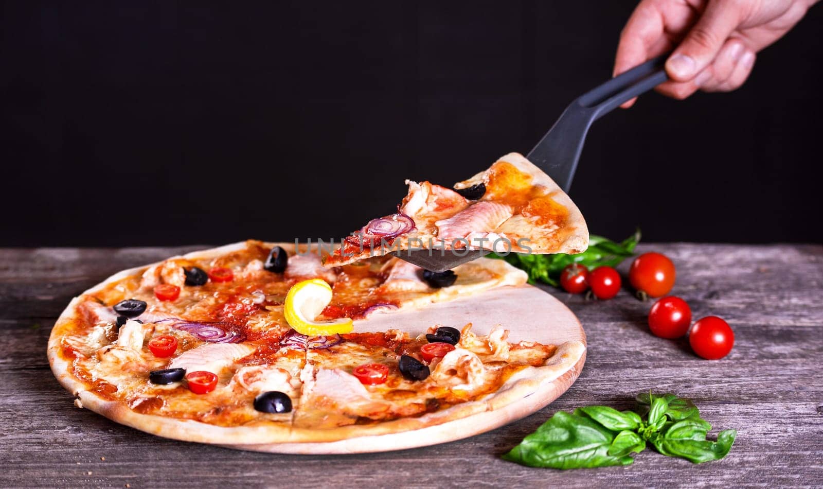 Delicious fresh Pizza with red fish and mozzarella on the wooden background. Top view.