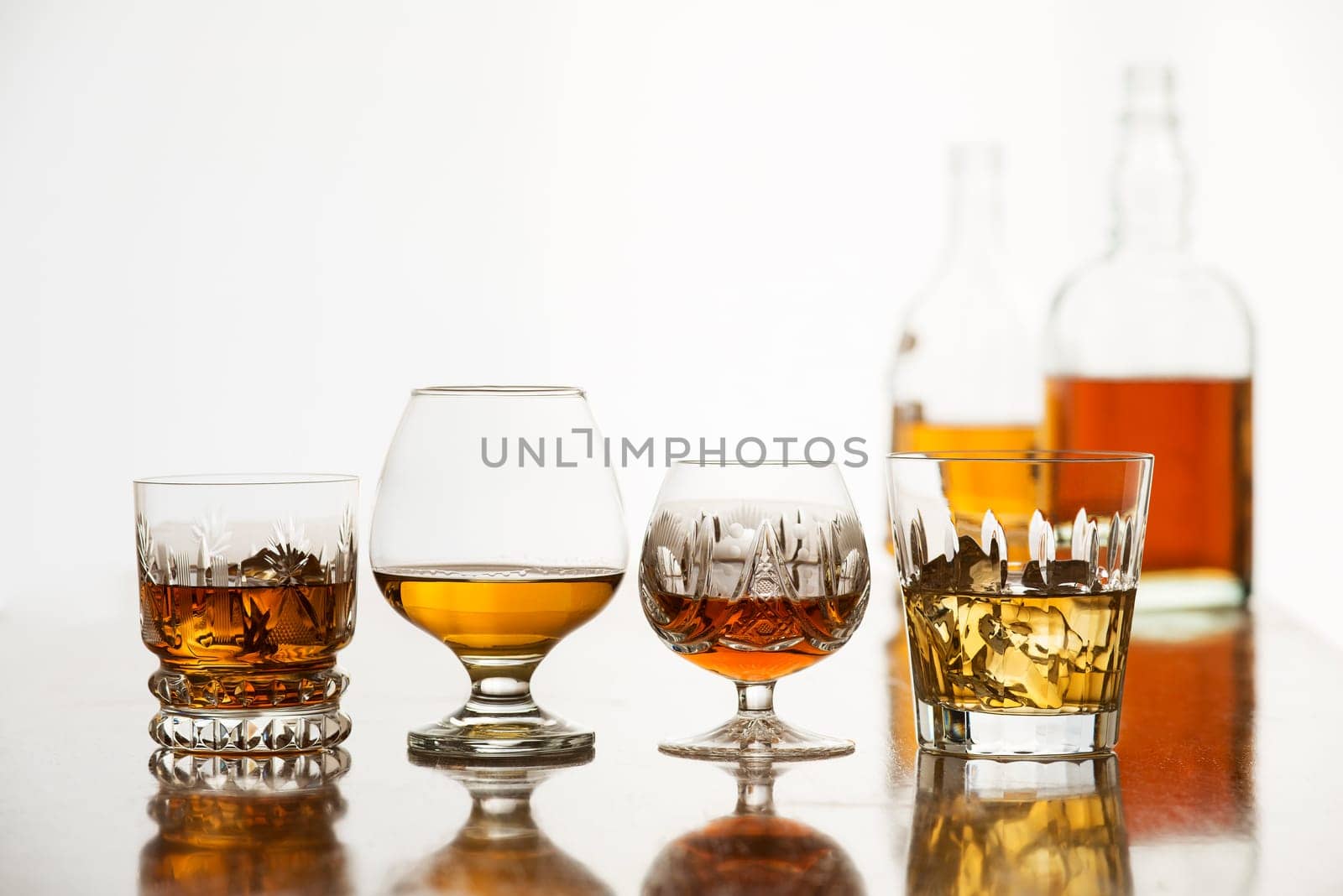 Whiskey, bourbon, cognac and brandy on white
