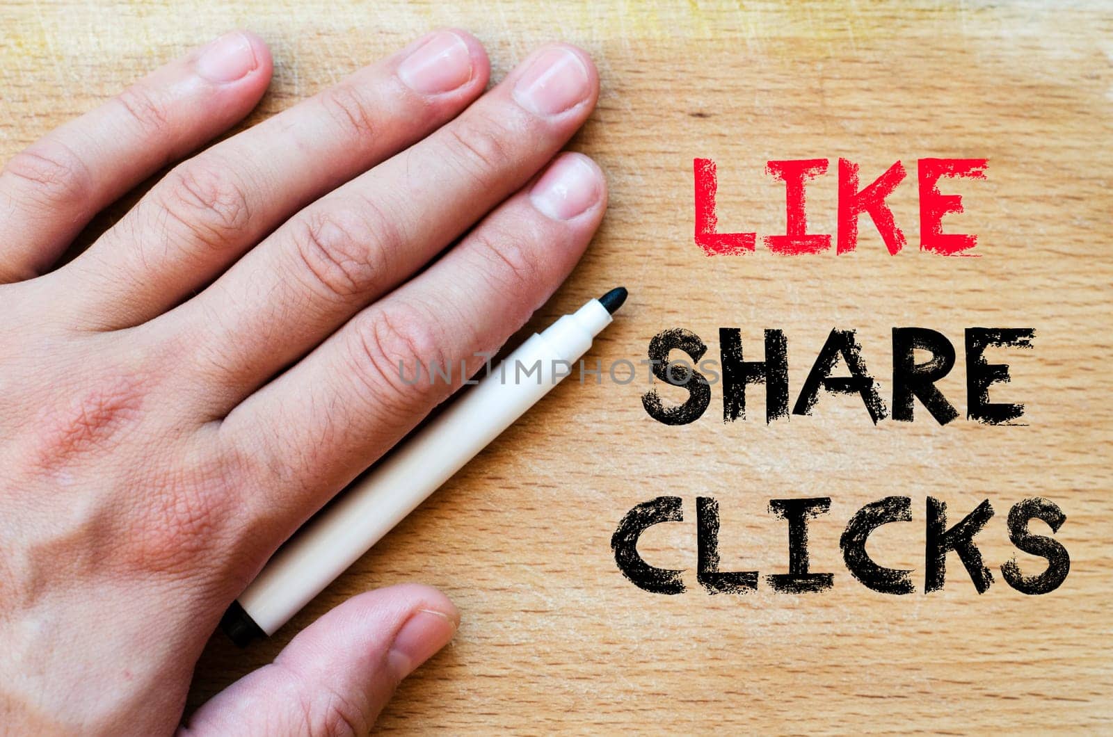 Human hand over wooden background and like share clicks text concept