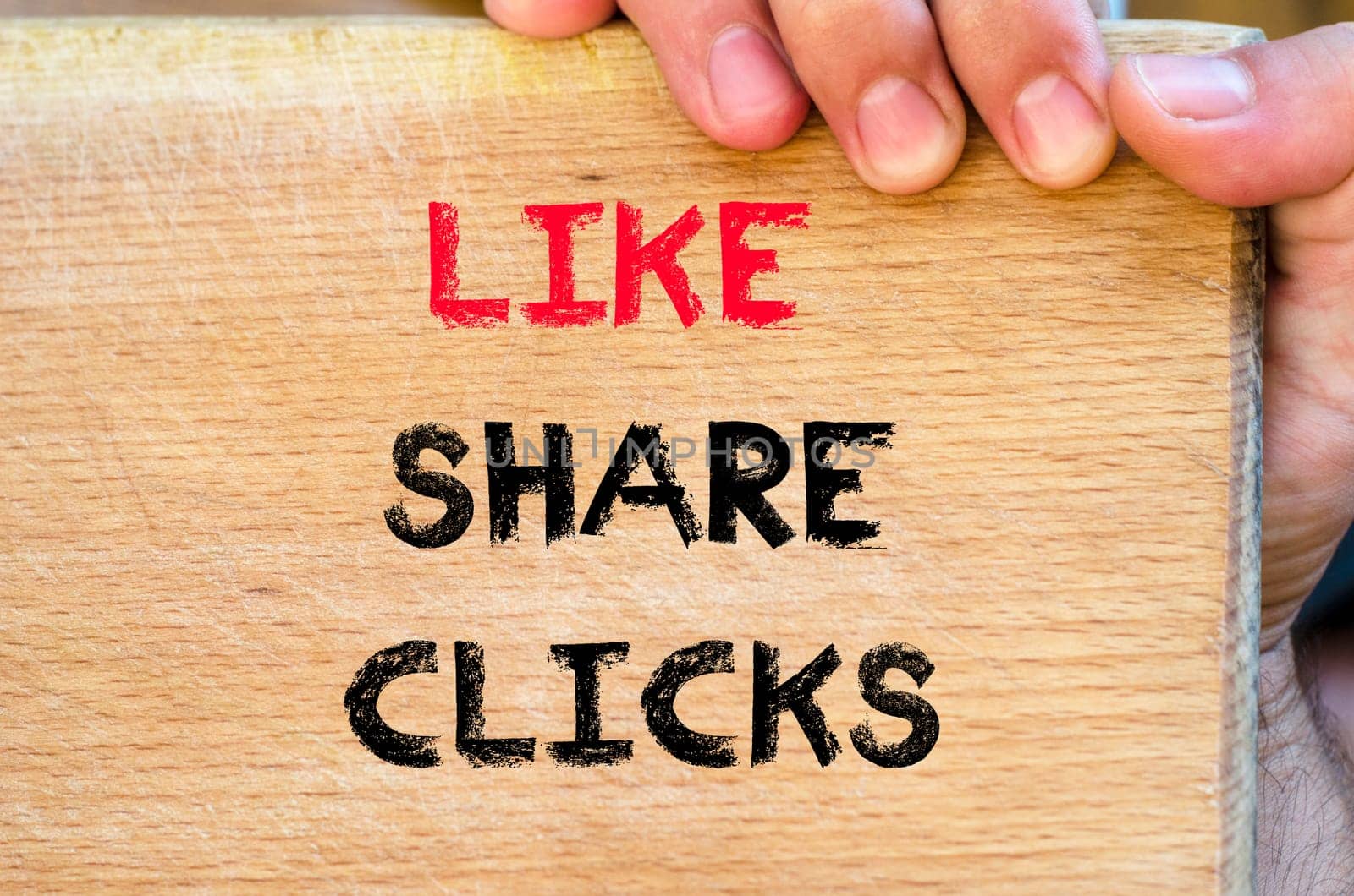 Human hand over wooden background and like share clicks text concept