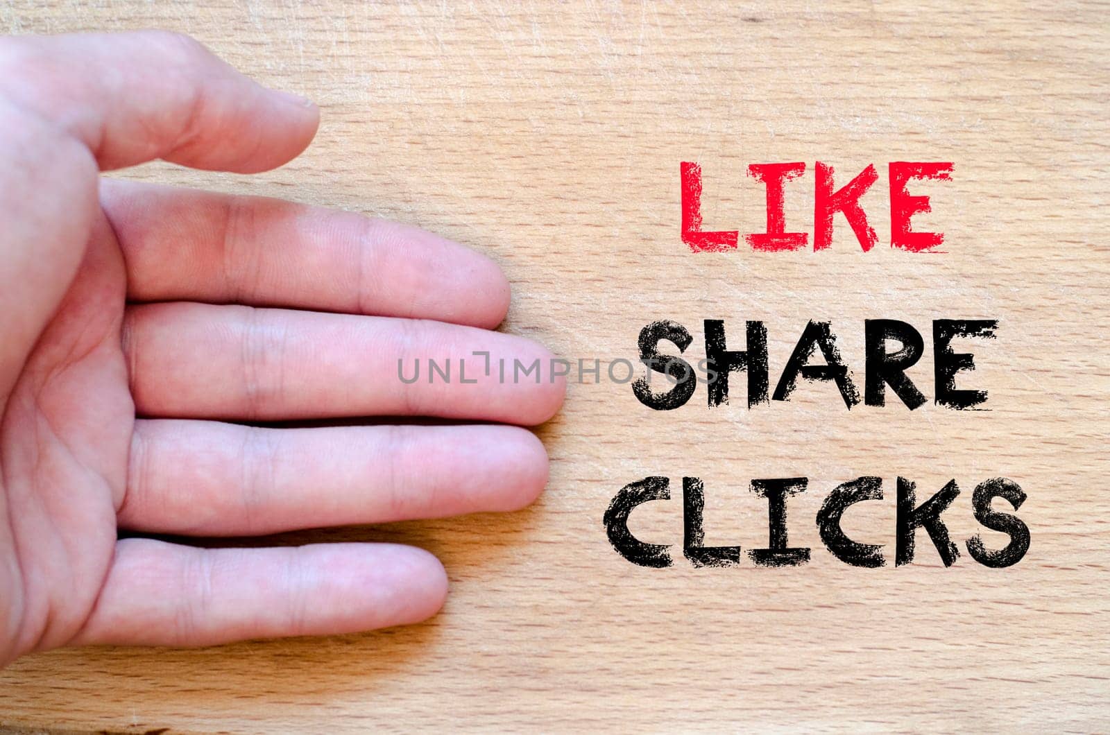 Human hand over wooden background and like share clicks text concept