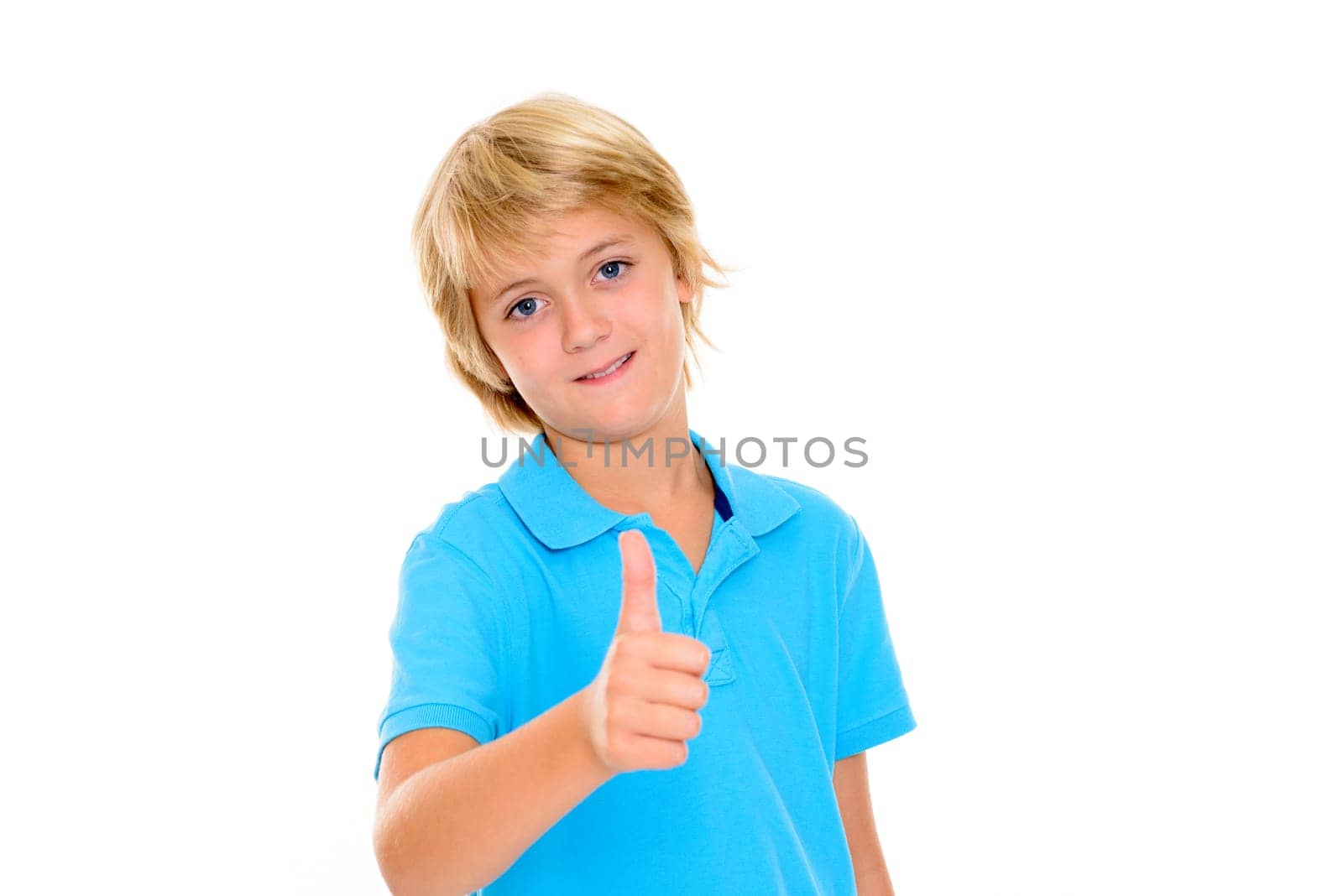 smiling blond boy with thumb up in front of white background