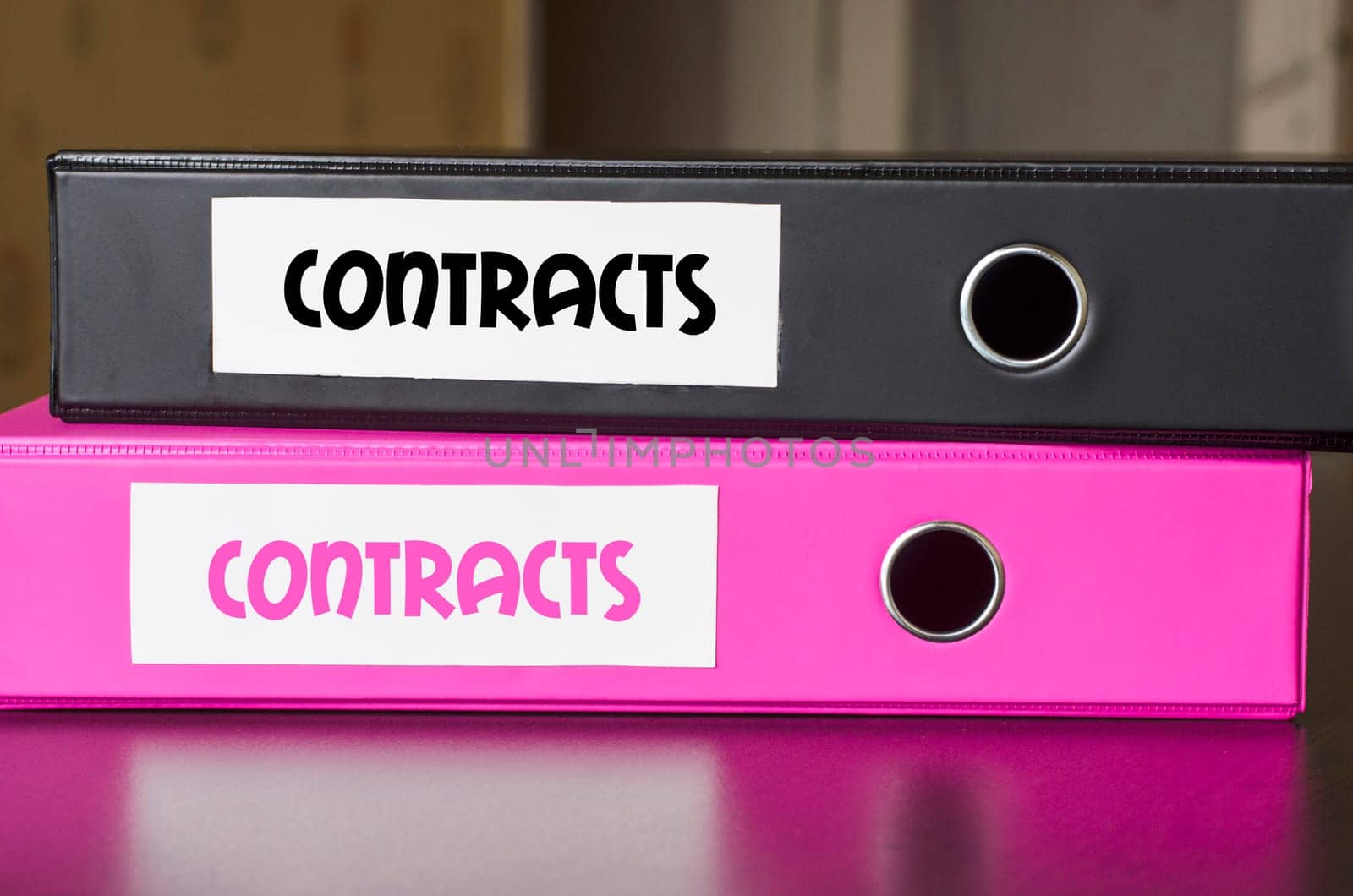 Bright office folders over dark background and contracts text concept