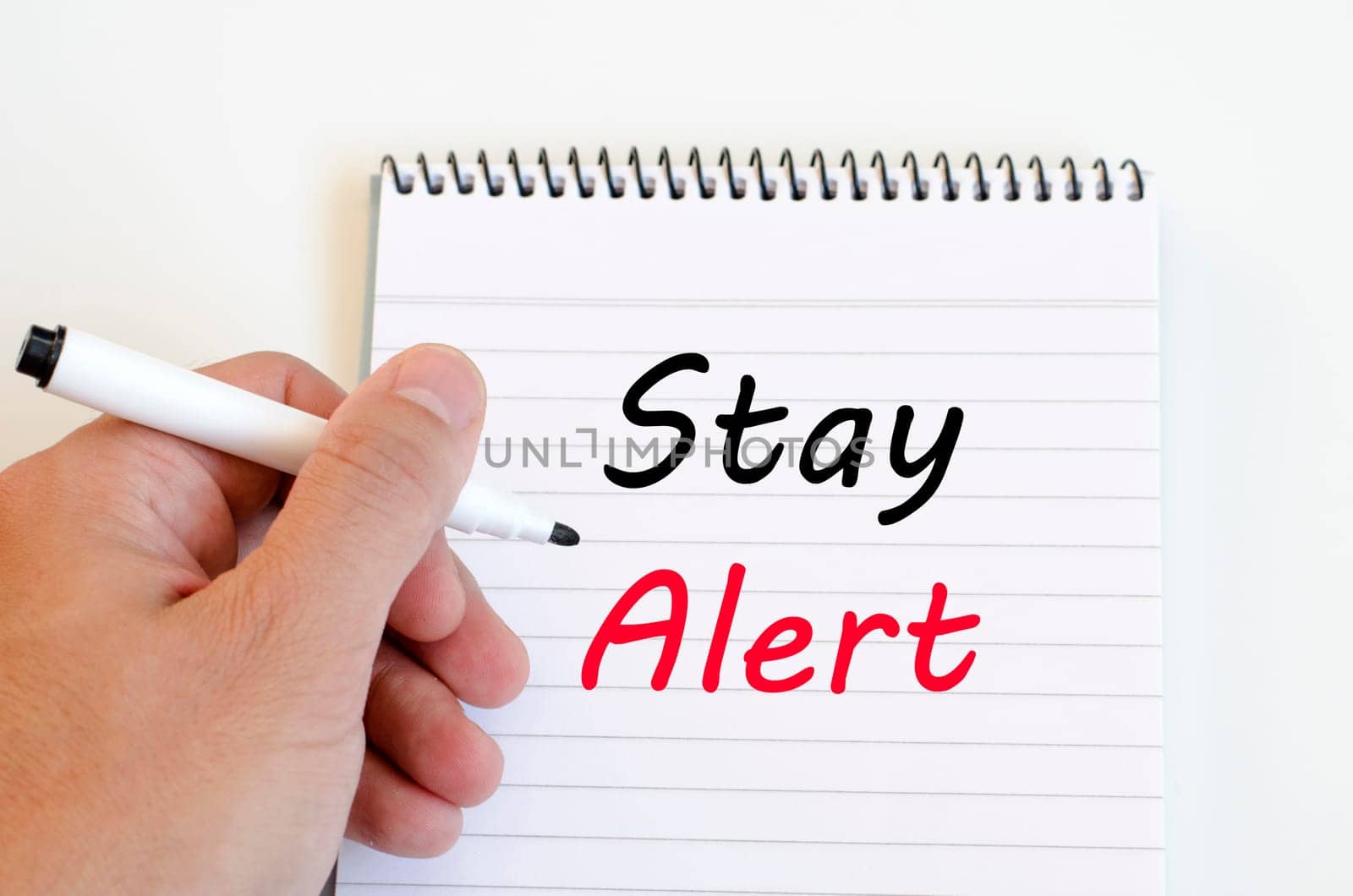 Stay alert text concept write on notebook