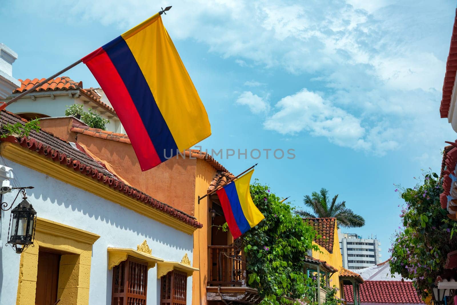 Colombian flags on a row of colonial buildings in the historic center of Cartagena, Colombia