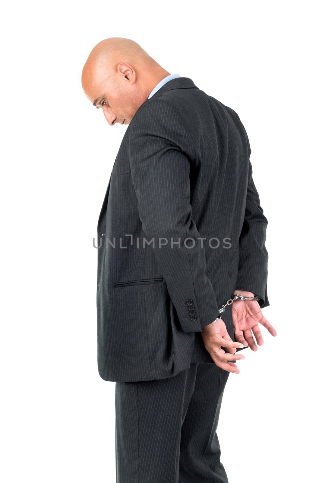 Businessman in handcuffs isolated in white background