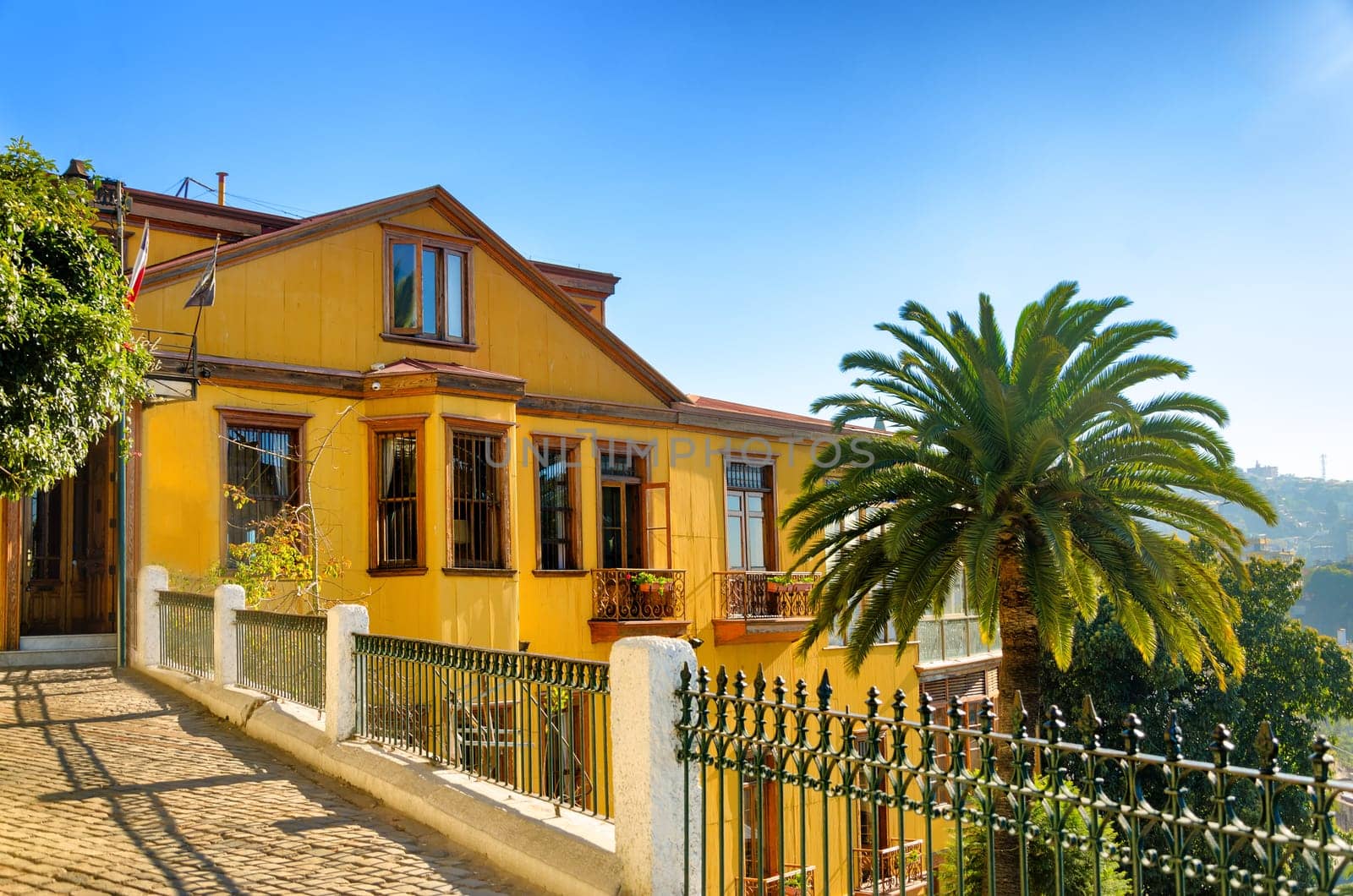 The house rests on a steep hill above the port in Valparaiso, Chile