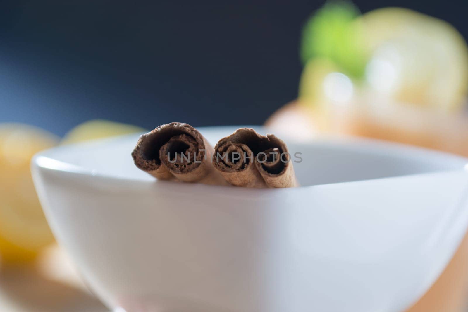 Pair of cinnamon sticks in a white bowl