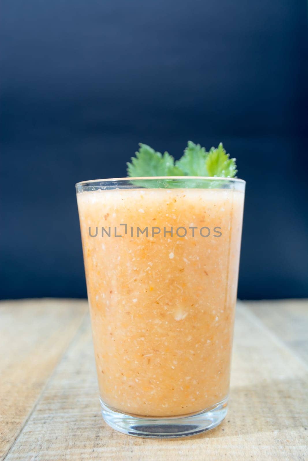 Fresh lemonade with ginger decorated with green celery leaves