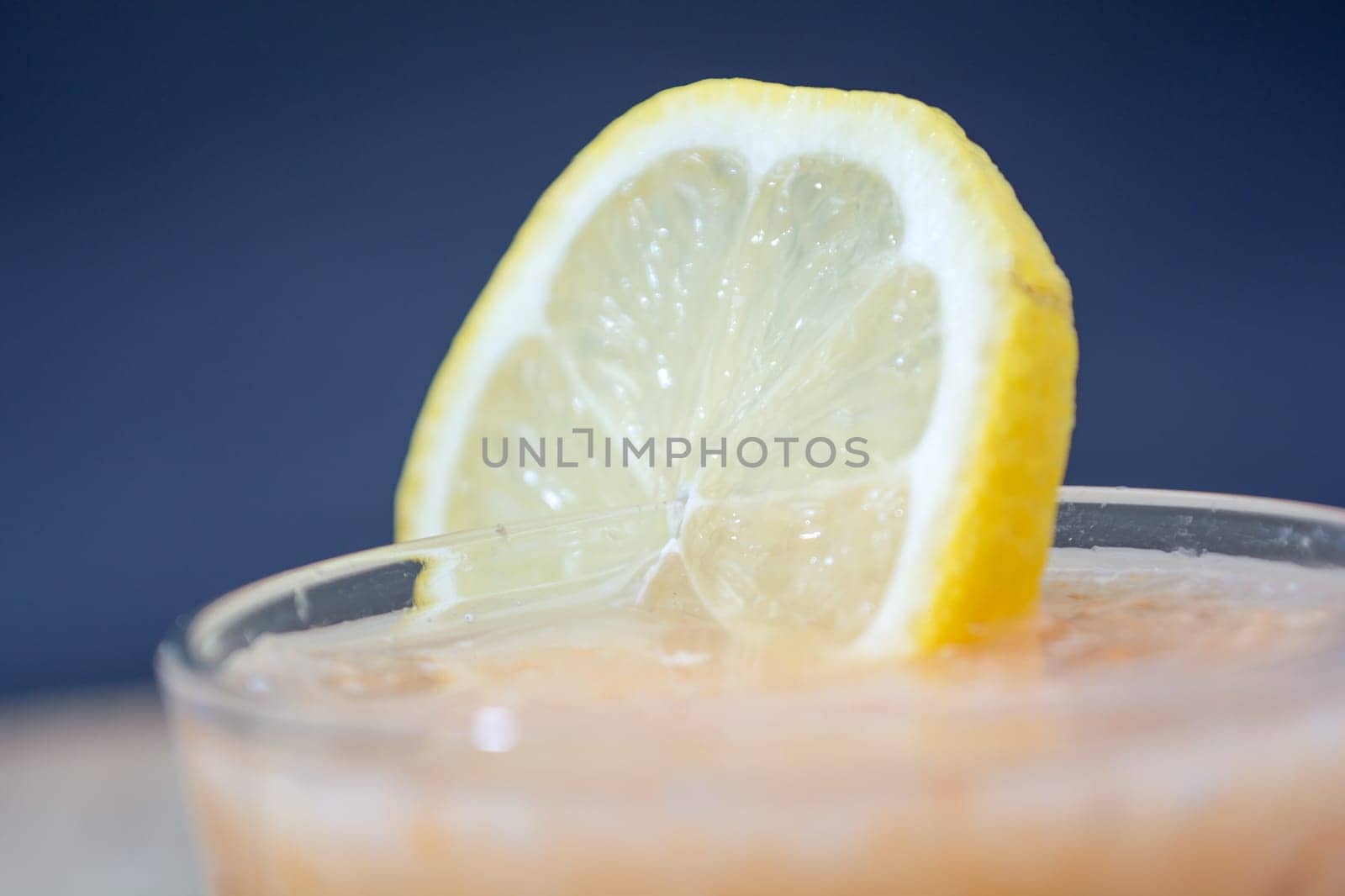 Fresh lemonade with ginger decorated with  lemon on the dark background