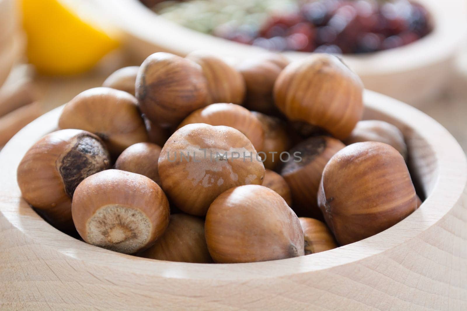 Hazelnuts  in wooden bowl ready to be cracked and eaten