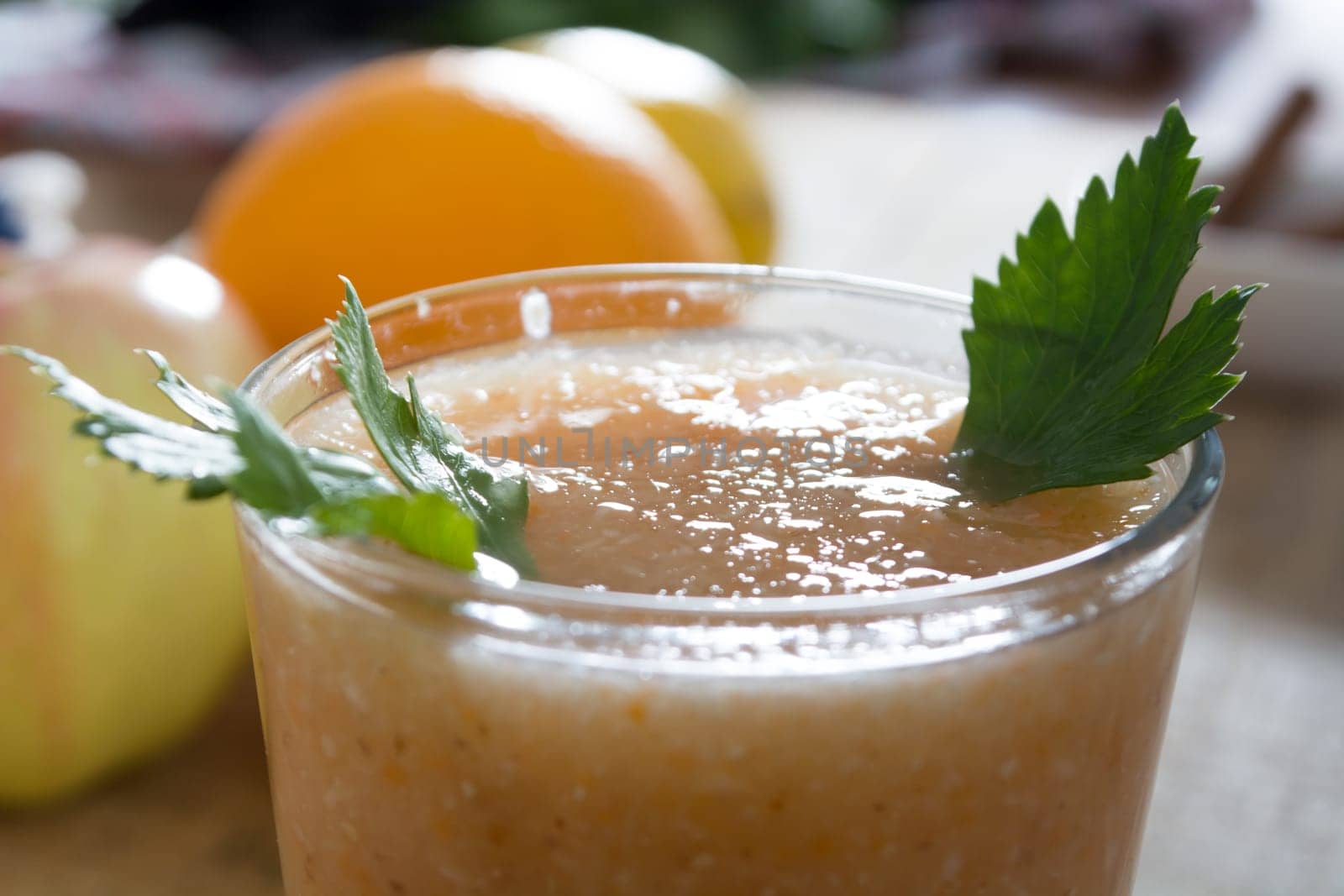 Fresh lemonade with ginger served on a table full with other fruits and cinnamon