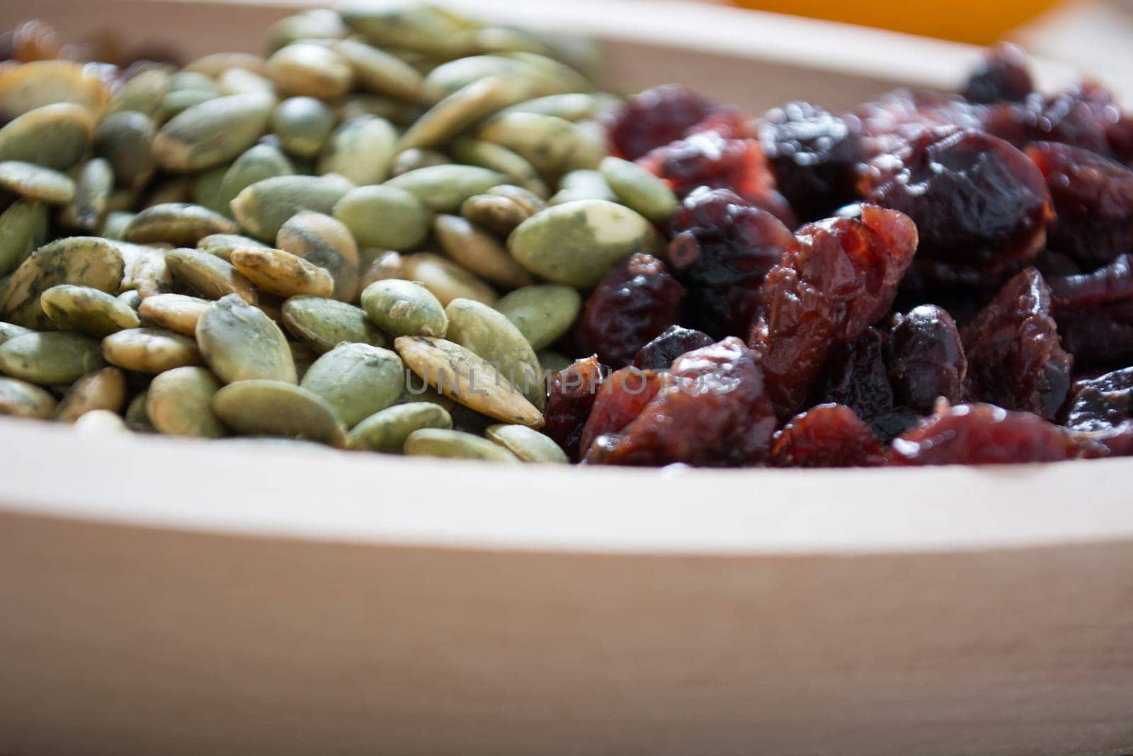 Dry fruit with pumpkin seed in the wooden bowl