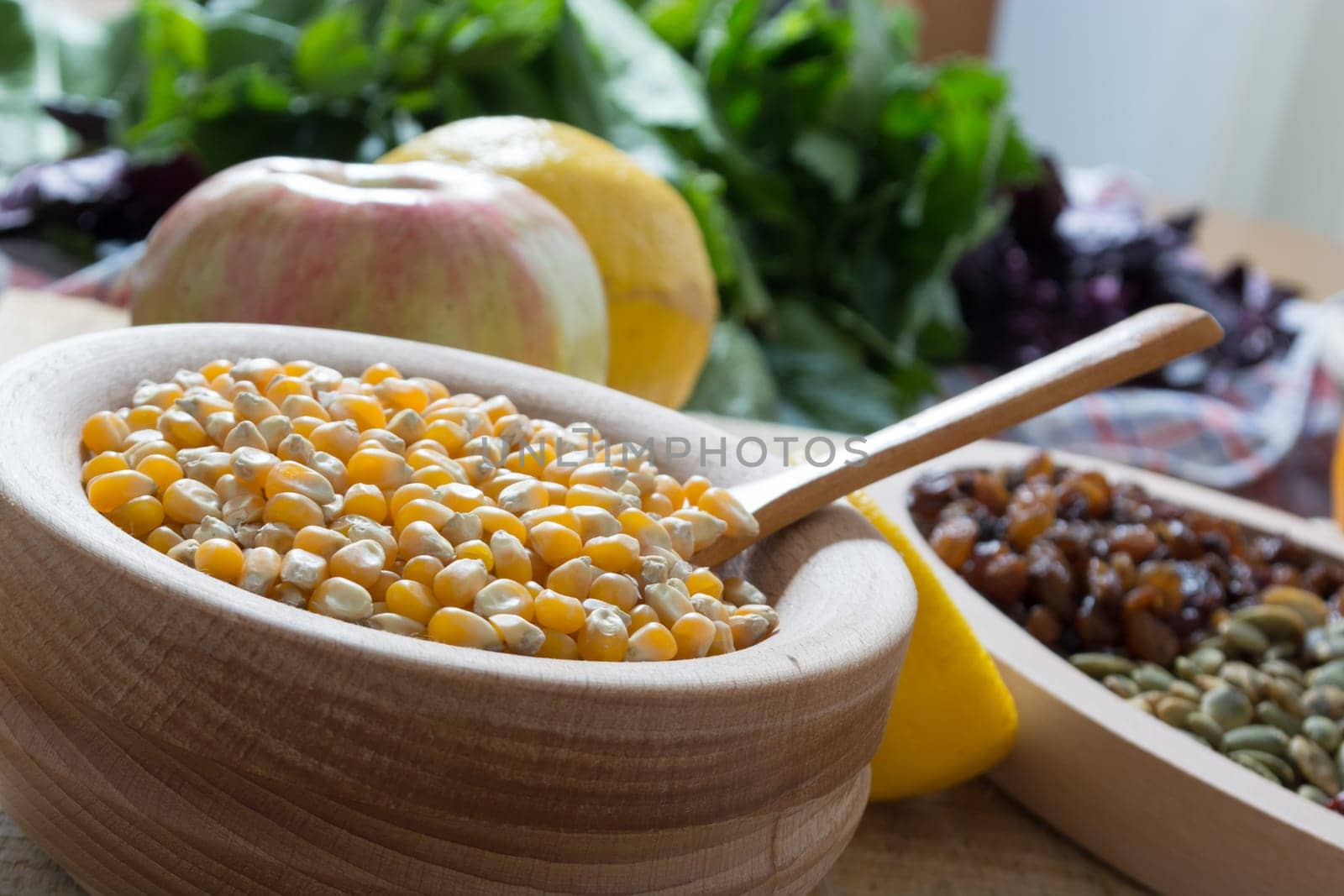 Corn seed in the wooden bowl with the wooden spoon