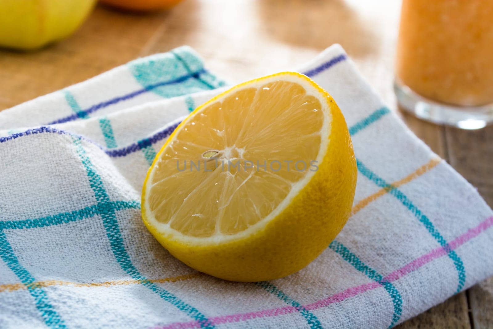 Lonely lemon on a kitchen cloth surrounded with other kitchen things
