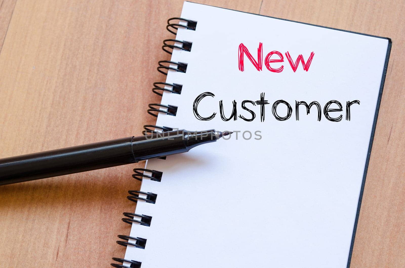 New customer text concept write on notebook