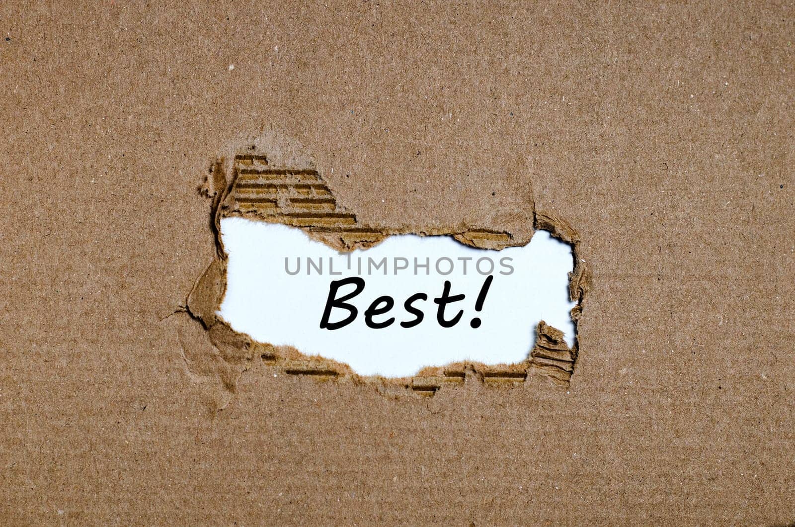 The word best appearing behind torn paper