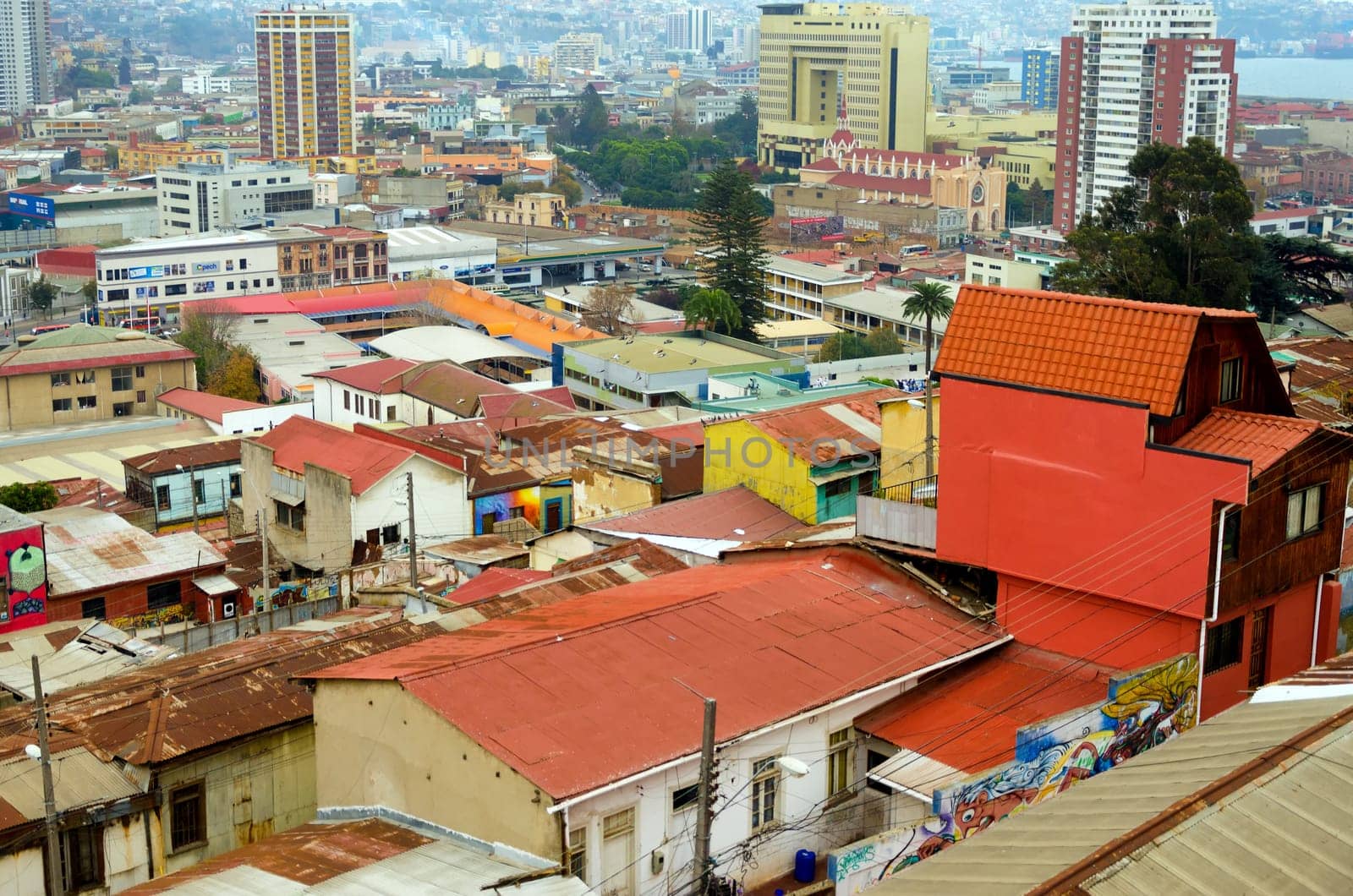 VALPARAISO, CHILE - MAY 28: The bright colors of the old town shine above the modern skyscrapers in Valparaiso, Chile on May 28, 2014