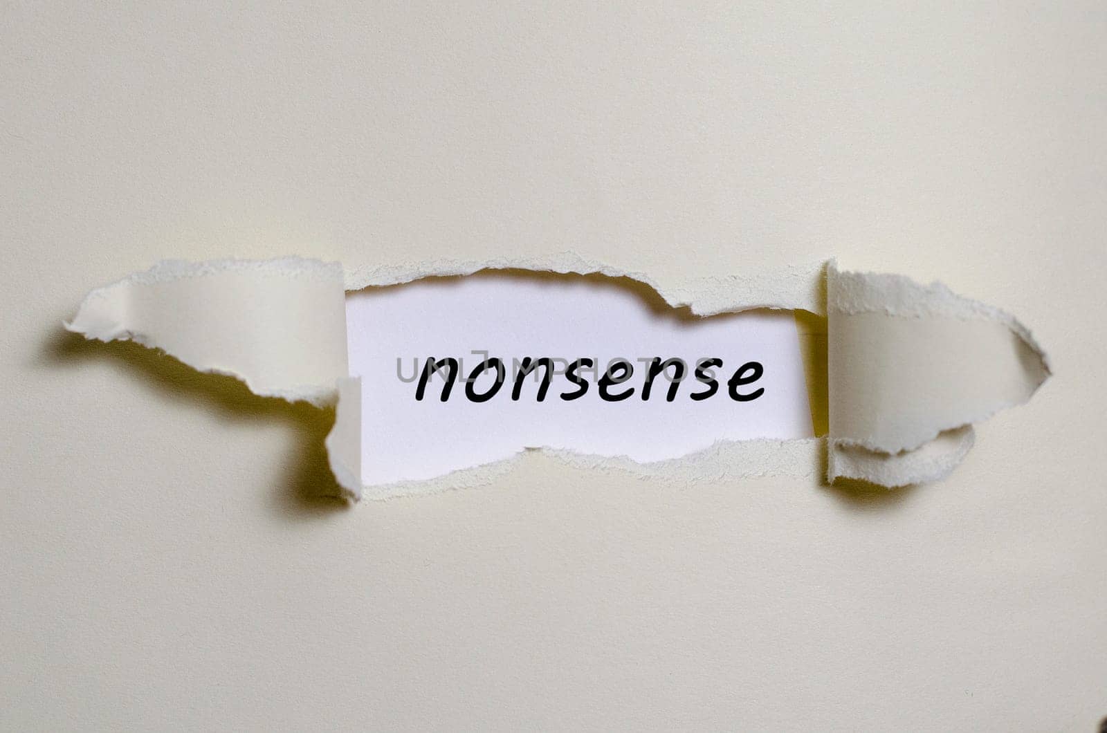 The word nonsense appearing behind torn paper