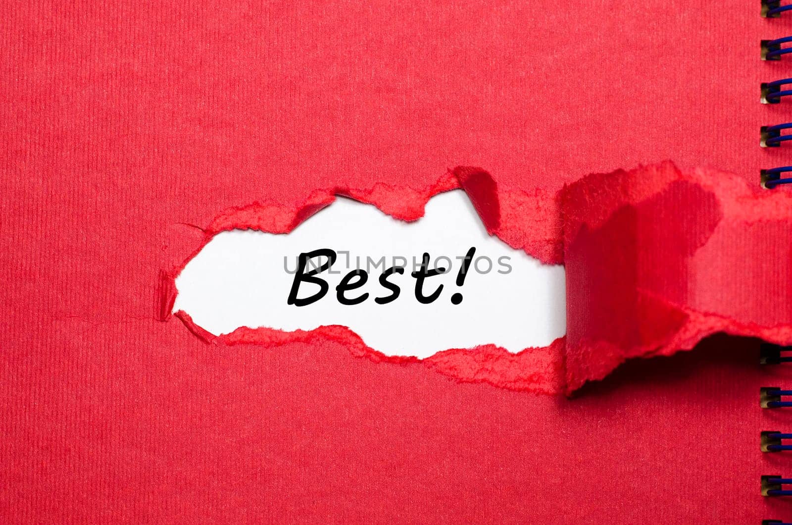 The word best appearing behind torn paper