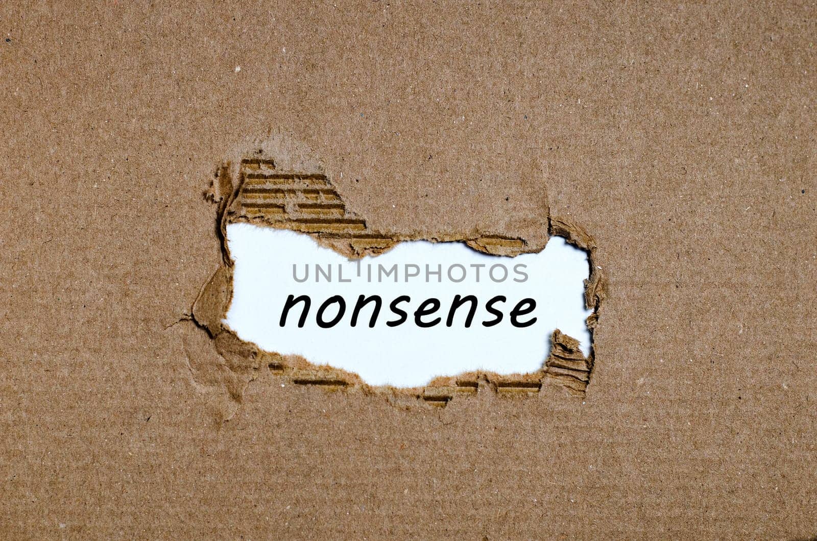 The word nonsense appearing behind torn paper