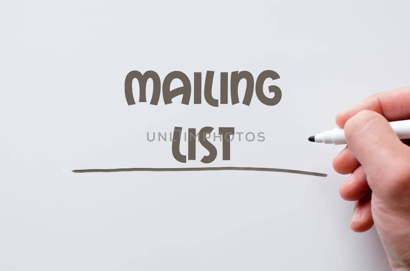 Human hand writing mailing list on whiteboard