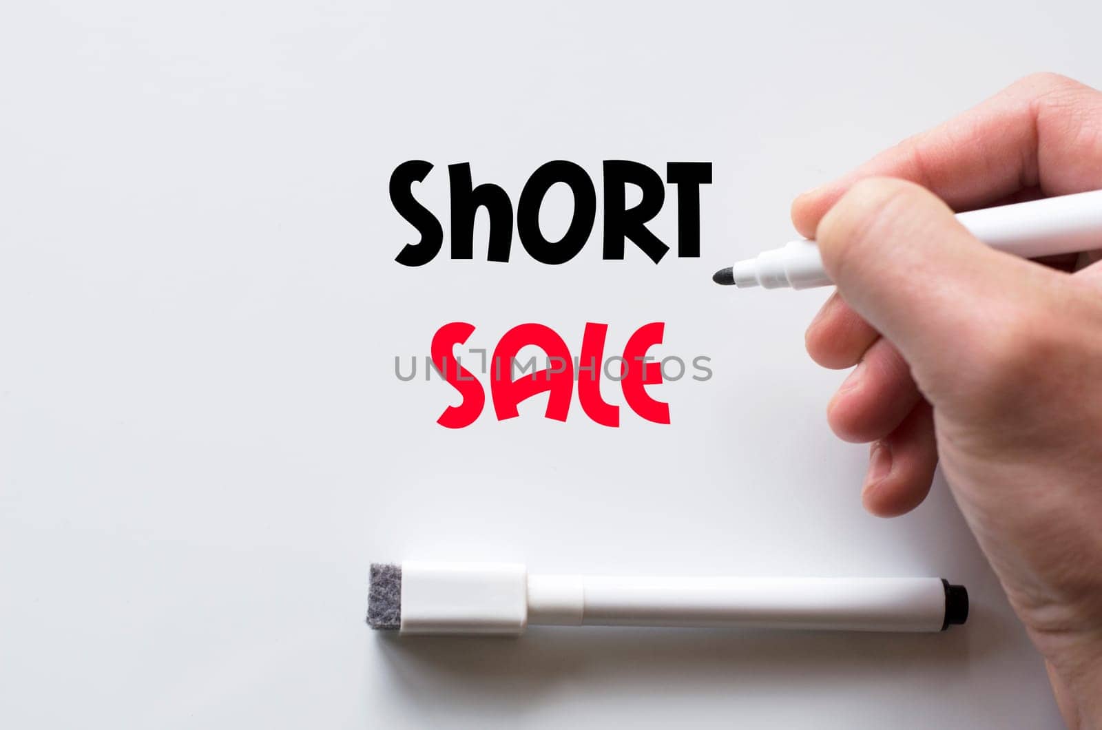 Human hand writing short sale on whiteboard