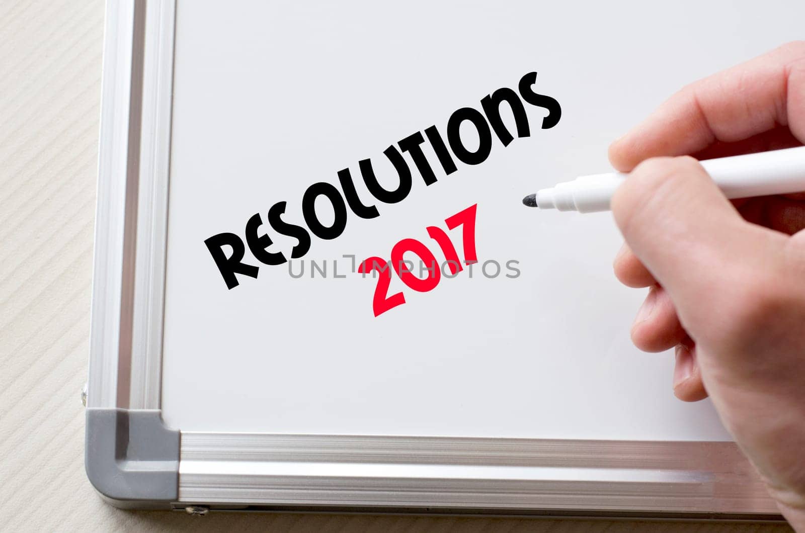 Human hand writing resolutions 2017 on whiteboard