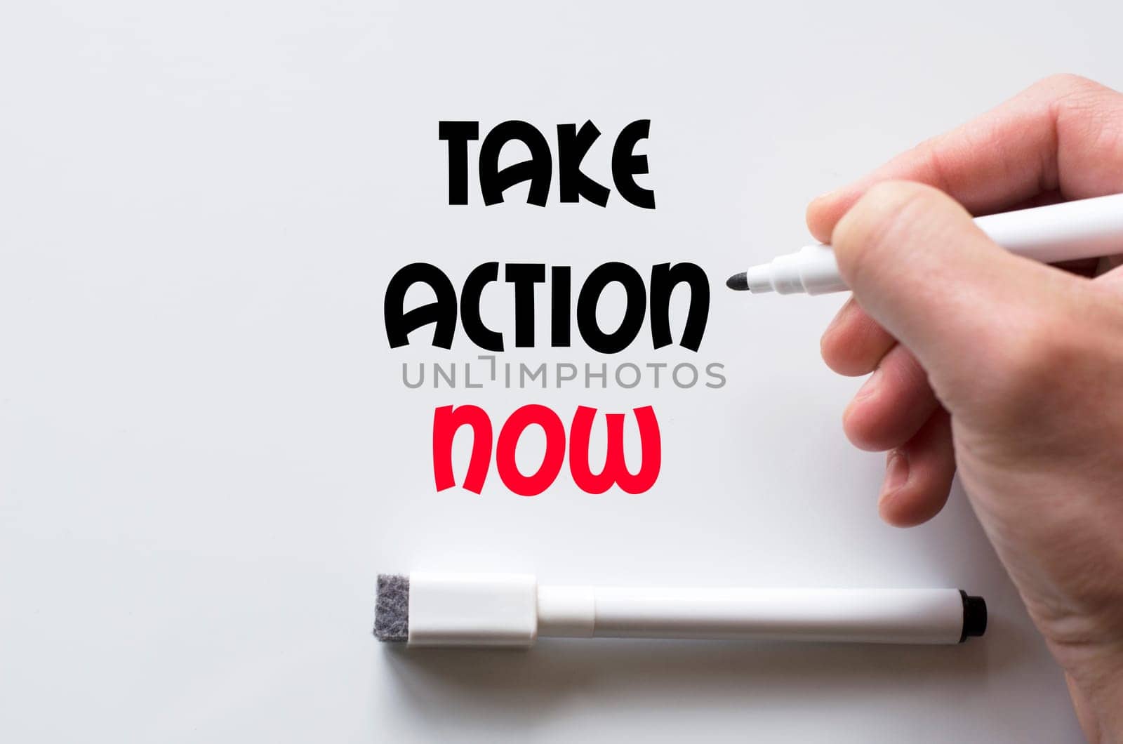 Human hand writing take action now on whiteboard