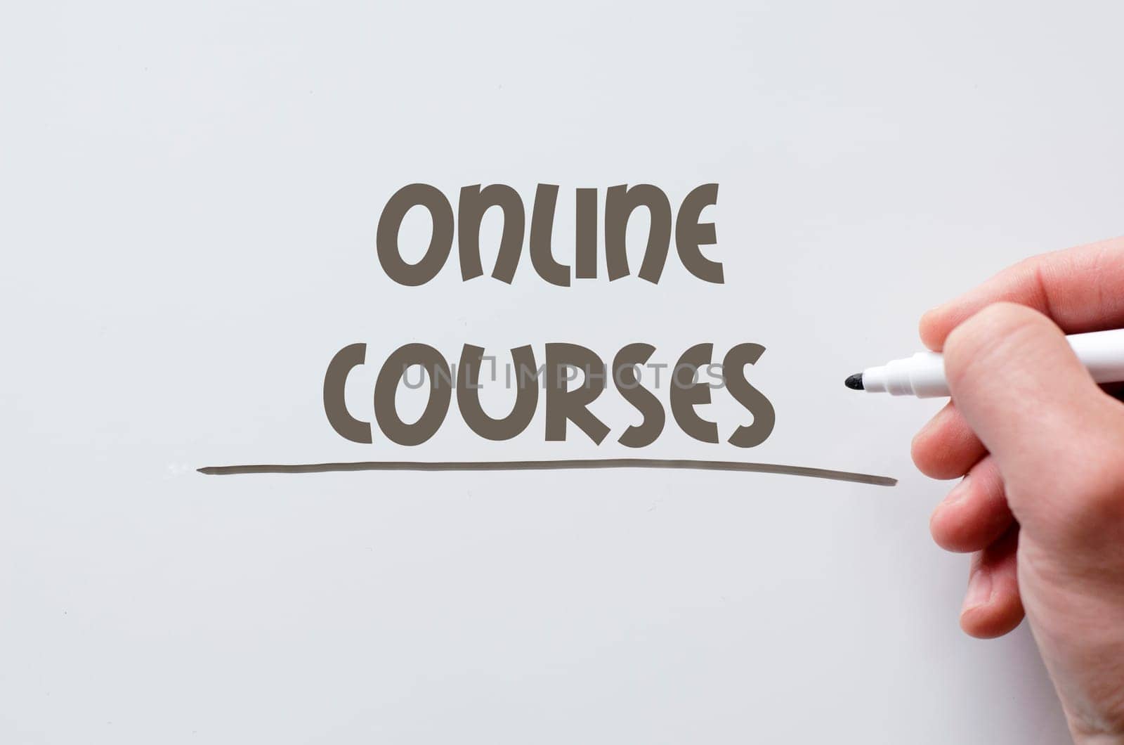 Human hand writing online courses on whiteboard