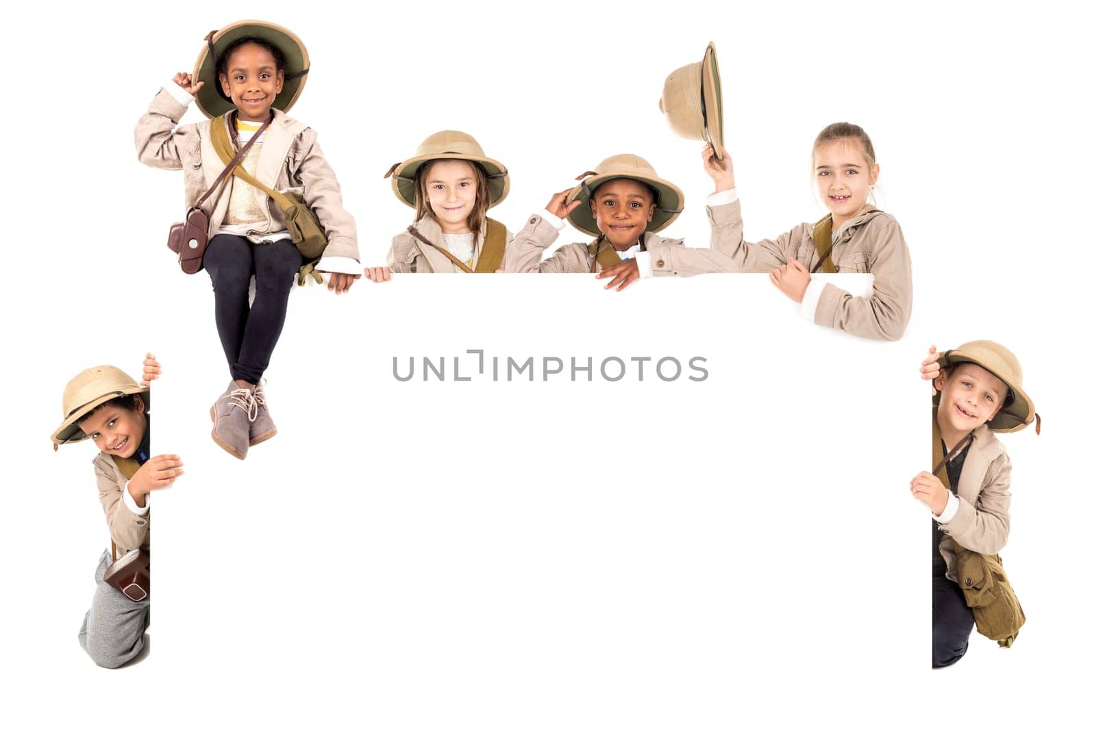 Children's group with safari clothes and gear over a white board