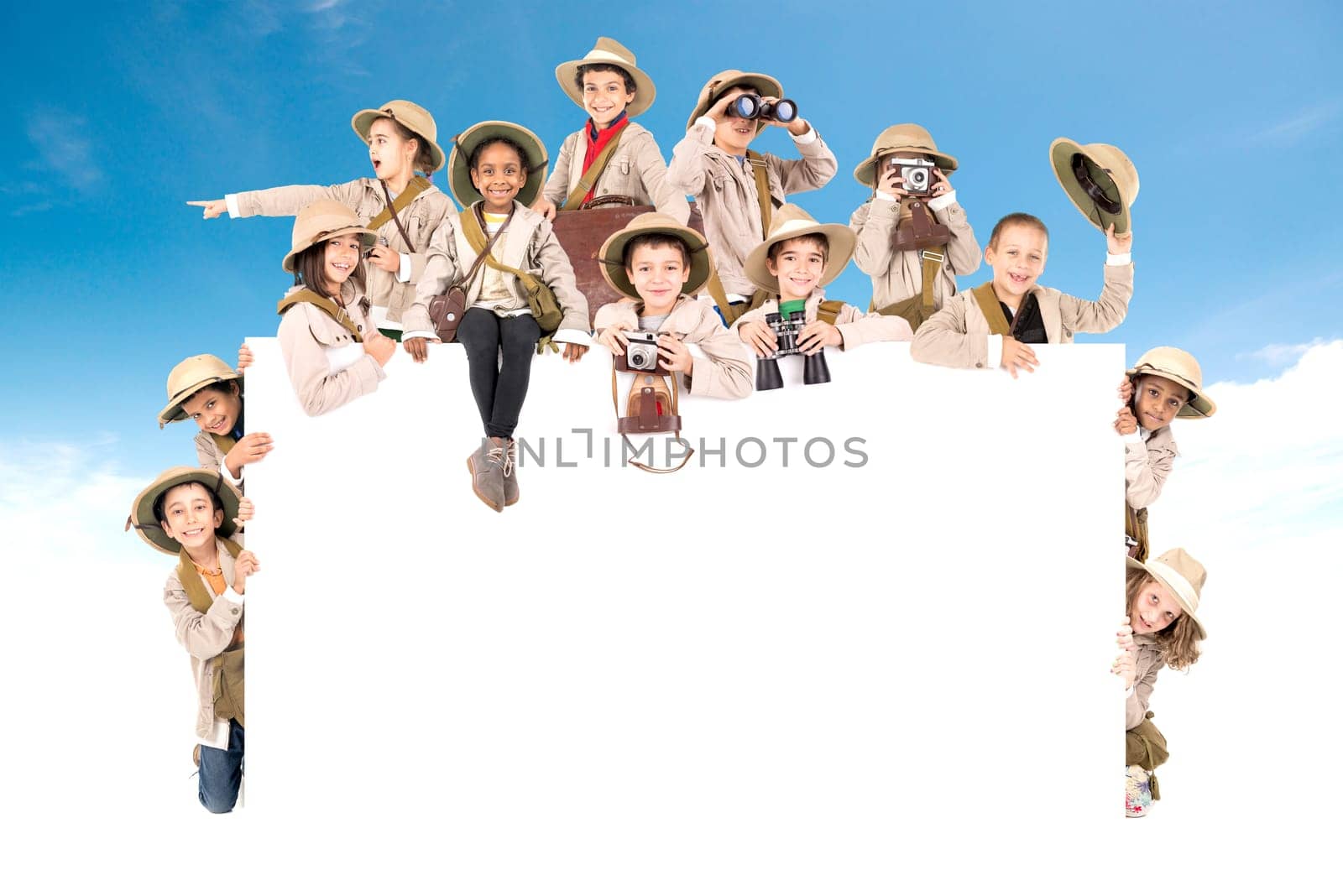 Children's group with safari clothes and gear over a white board