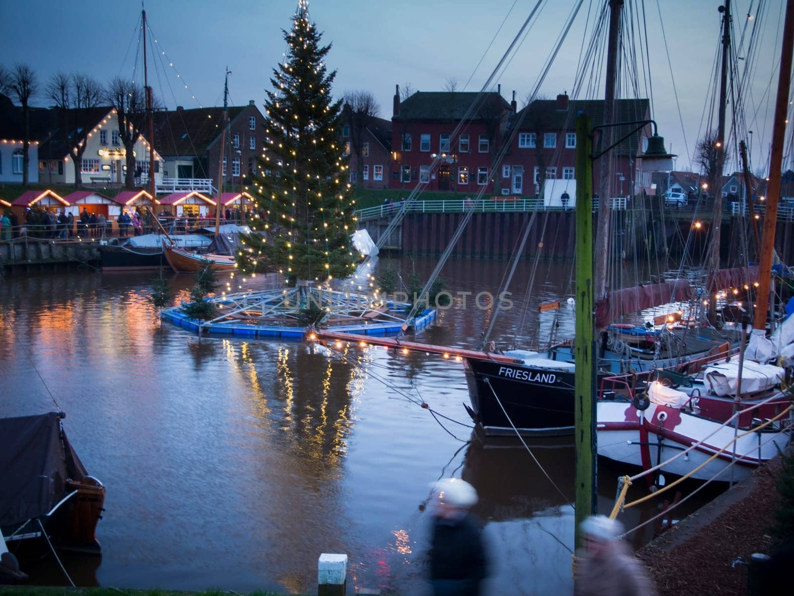 Port of Carolinensiel with floating Christmas tree at dusk