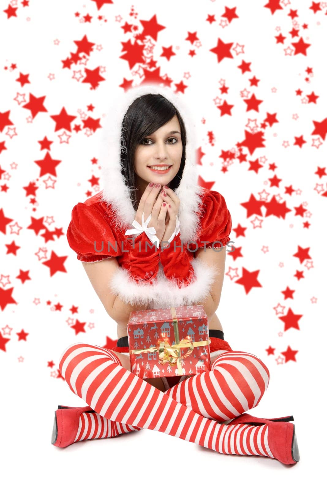beautiful sexy girl wearing santa claus clothes with gift, red stars background