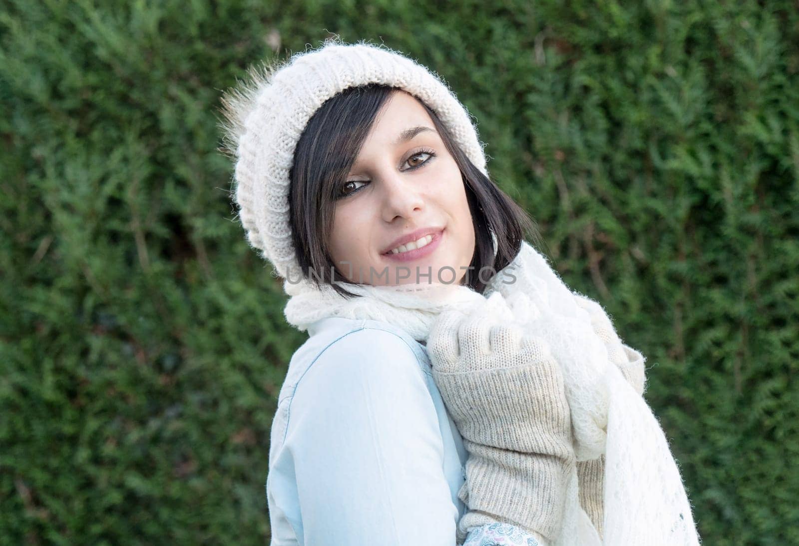 portrait of a pretty young brunette with winter hat, outdoor