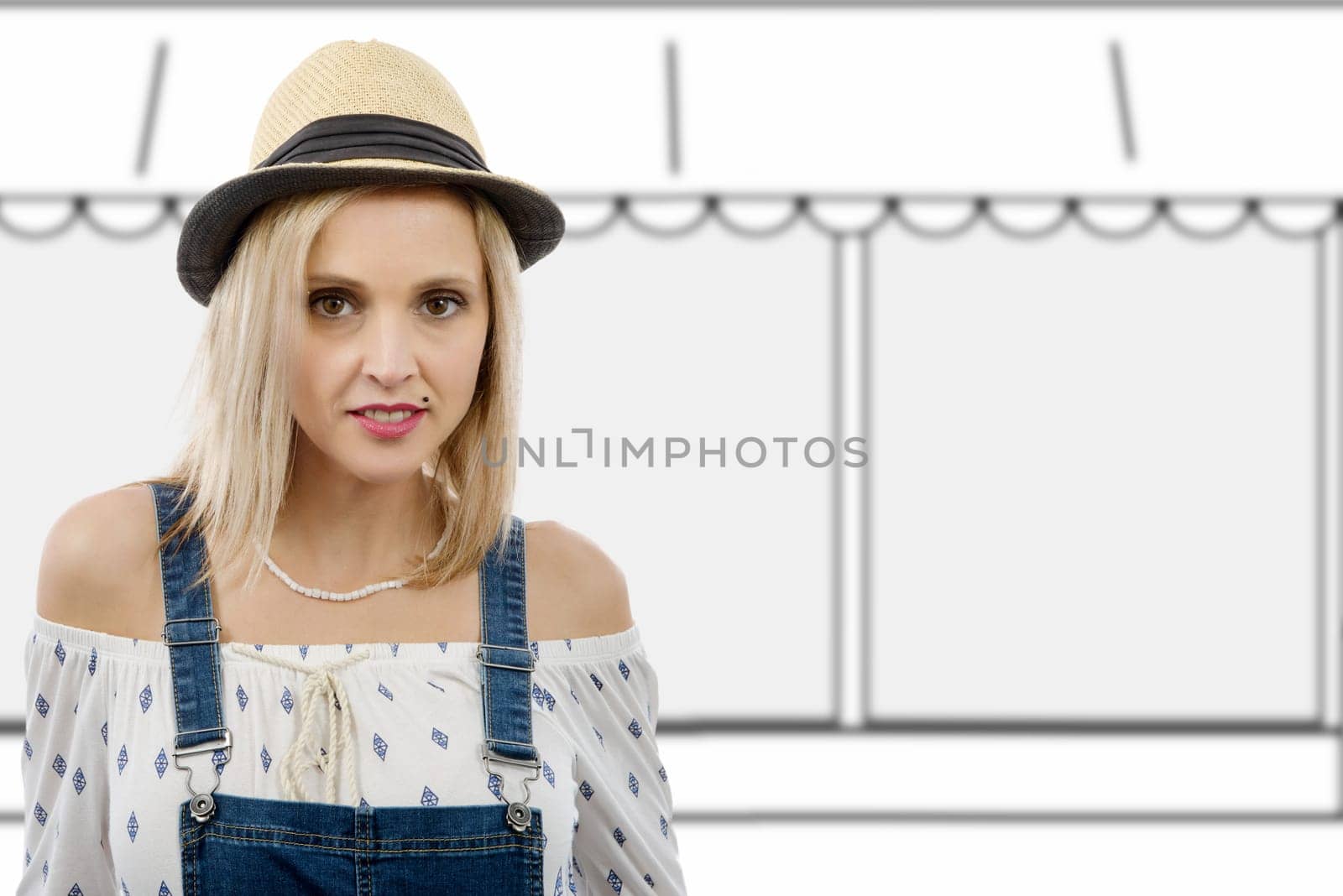 Portrait of beautiful blond woman  posing with summer hat