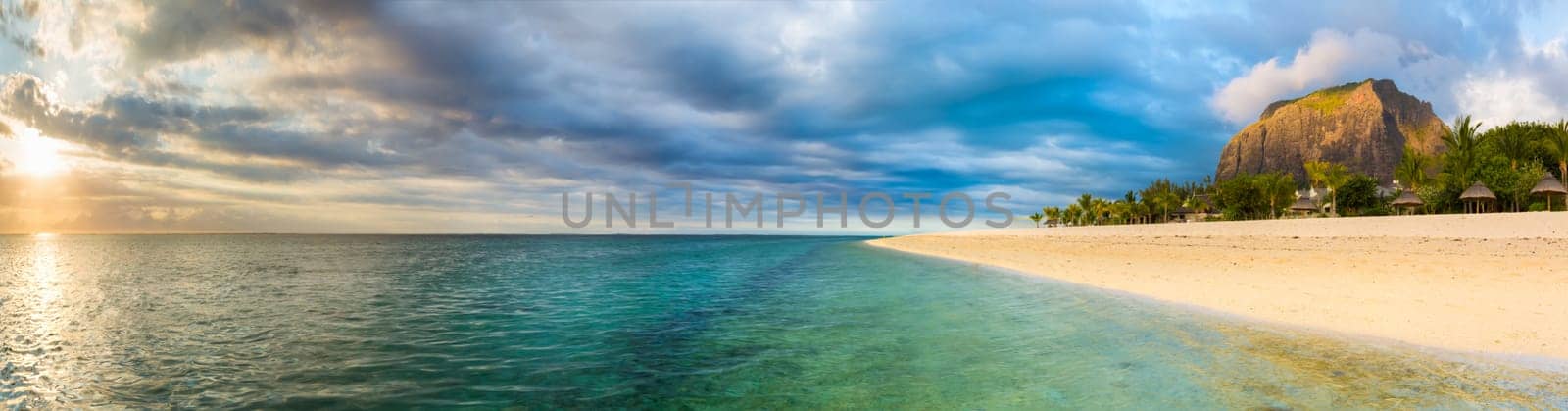 White sandy beach and Le Morn Brabant at sunset. Mauritius. Panorama