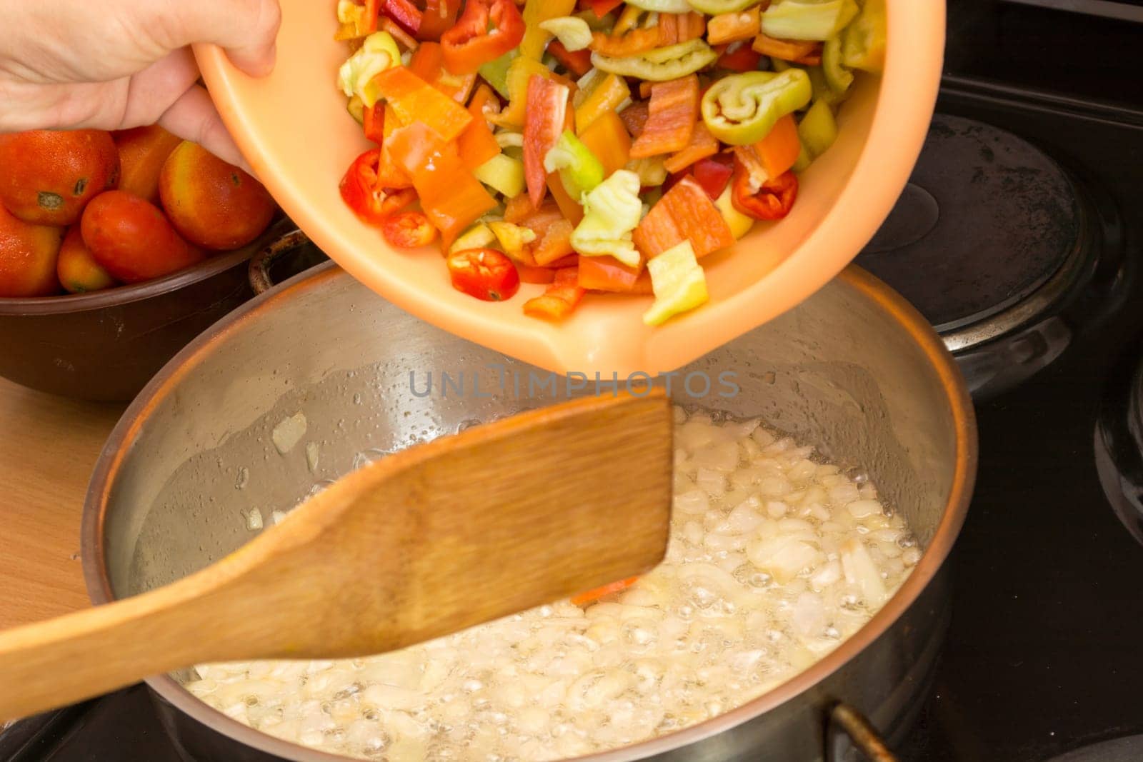 Adding fresh and chopped vegetables in stew