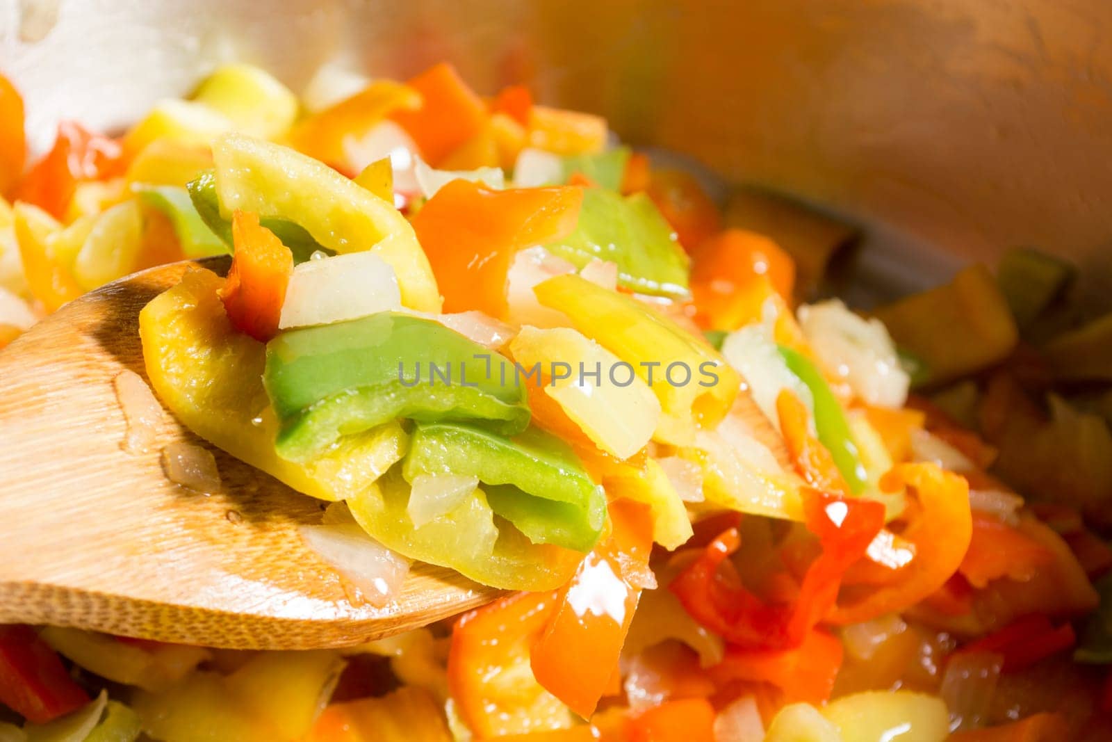 Cooking stew with fresh vegetables in a pot. Mixing it with mixing spoon