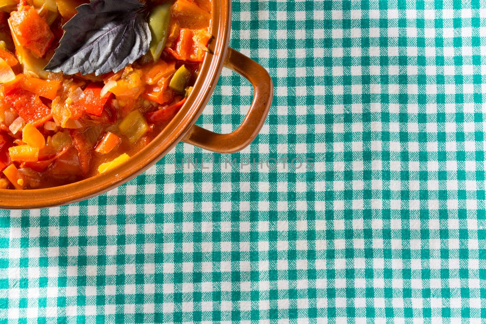Closeup of delicious stew with mixed vegetables, arranged with green and purple leaves