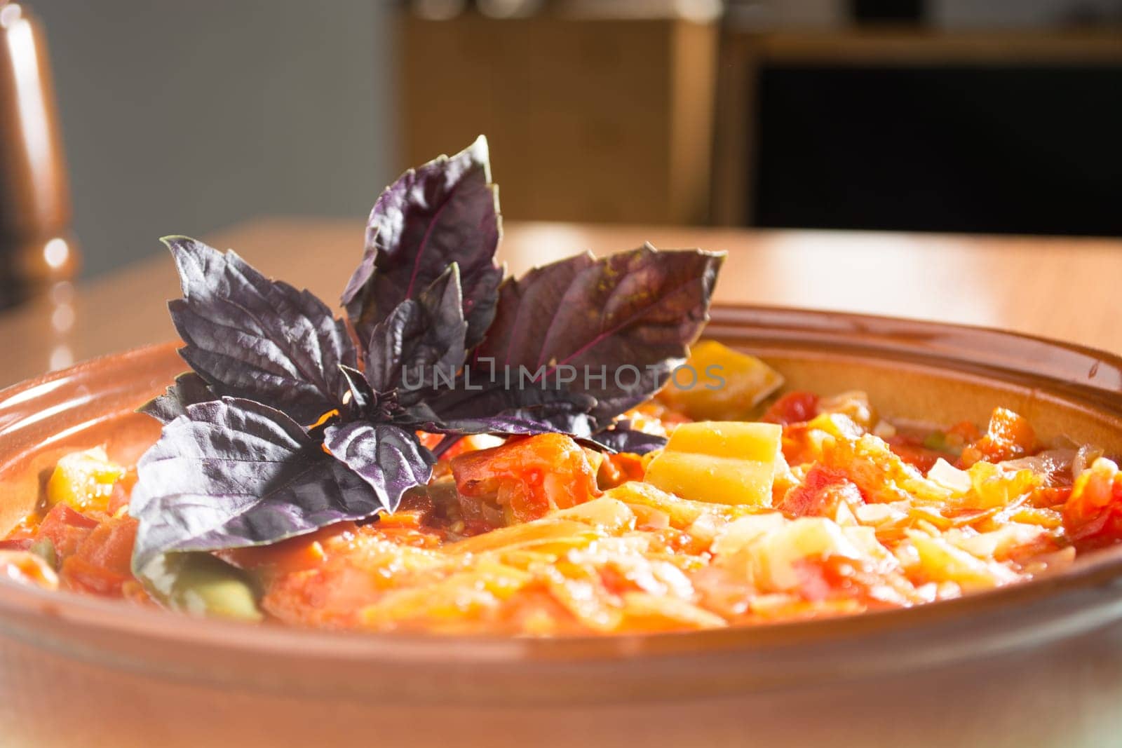 Closeup of delicious stew with mixed vegetables, arranged with purple leaves