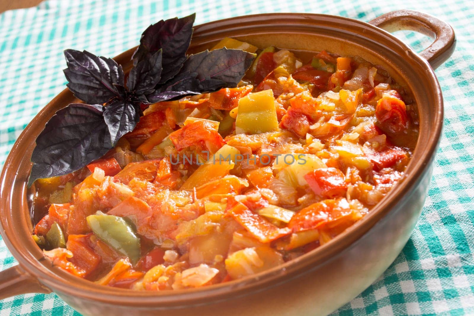 Closeup of delicious stew with mixed vegetables, arranged with purple leaves