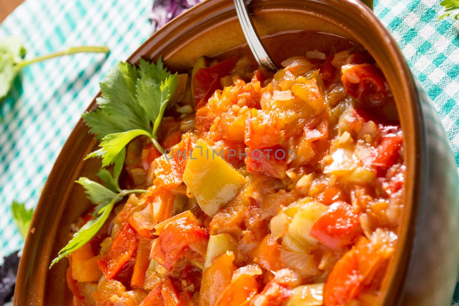Closeup of delicious stew with mixed vegetables, arranged with green and purple leaves